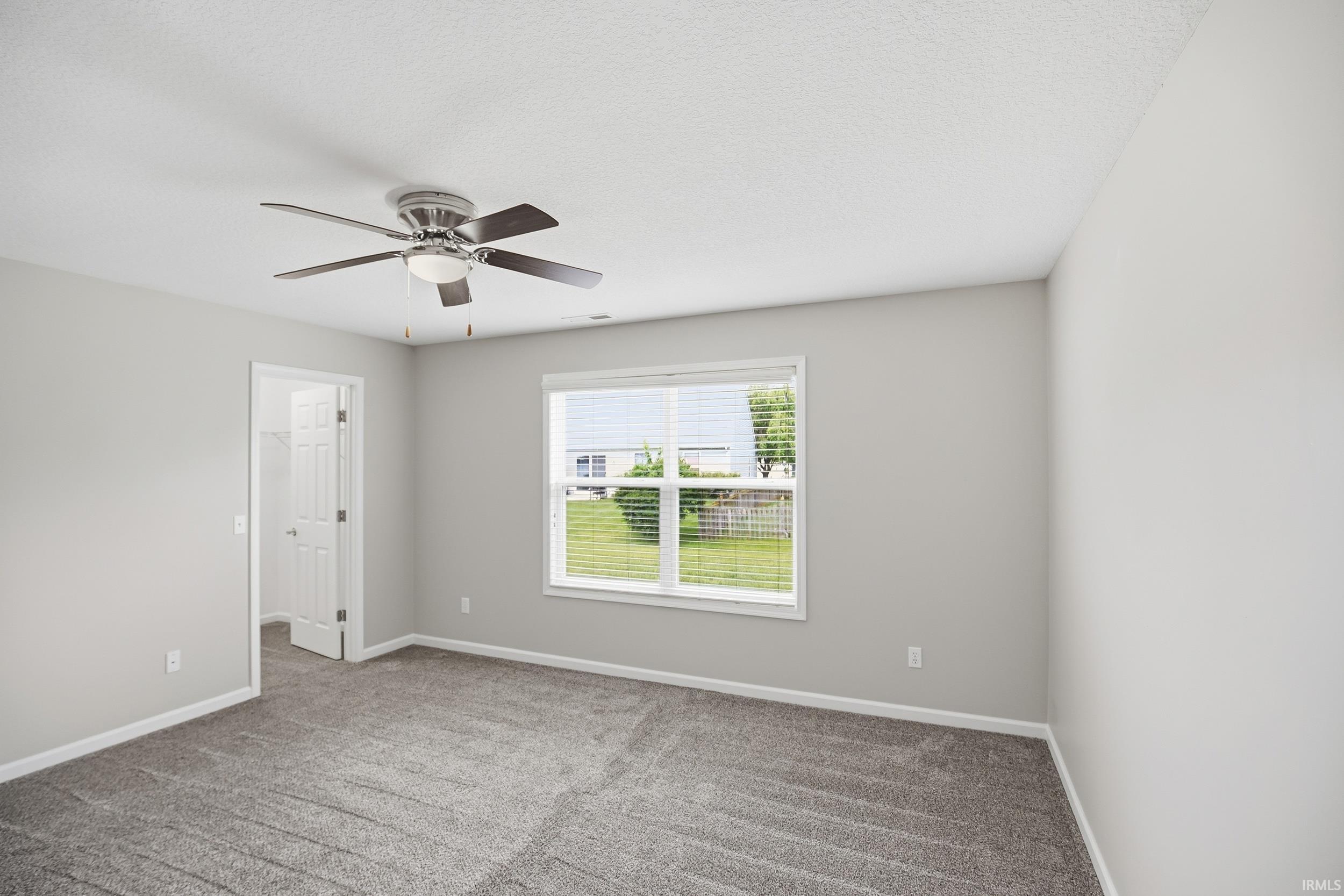 Carpeted room featuring light gray walls and white trim