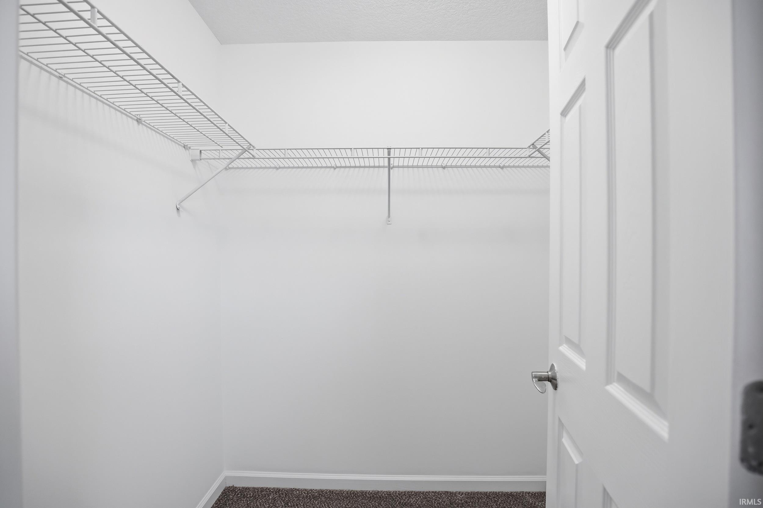 White wire shelving system providing storage