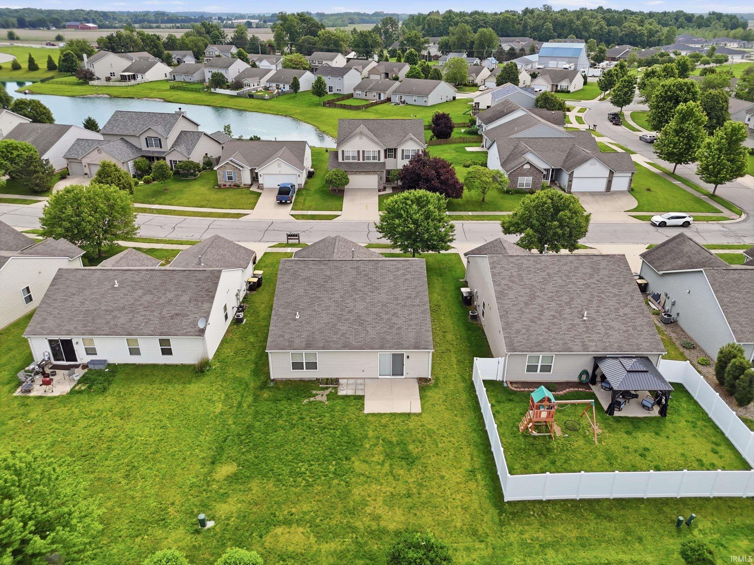 Expansive residential community featuring a prominent central pond surrounded by homes