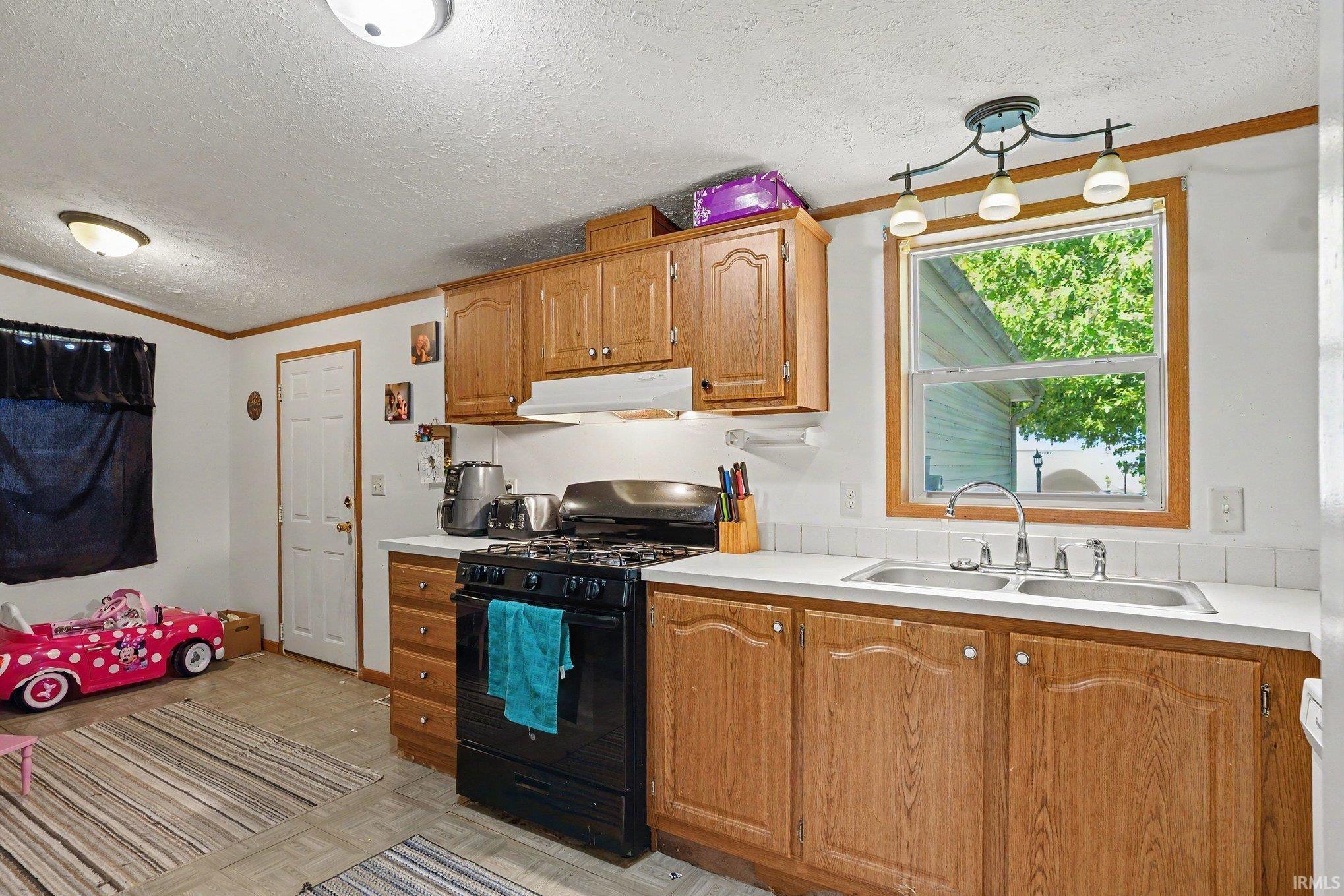 Kitchen featuring wood cabinetry, white countertops, and a tile backsplash