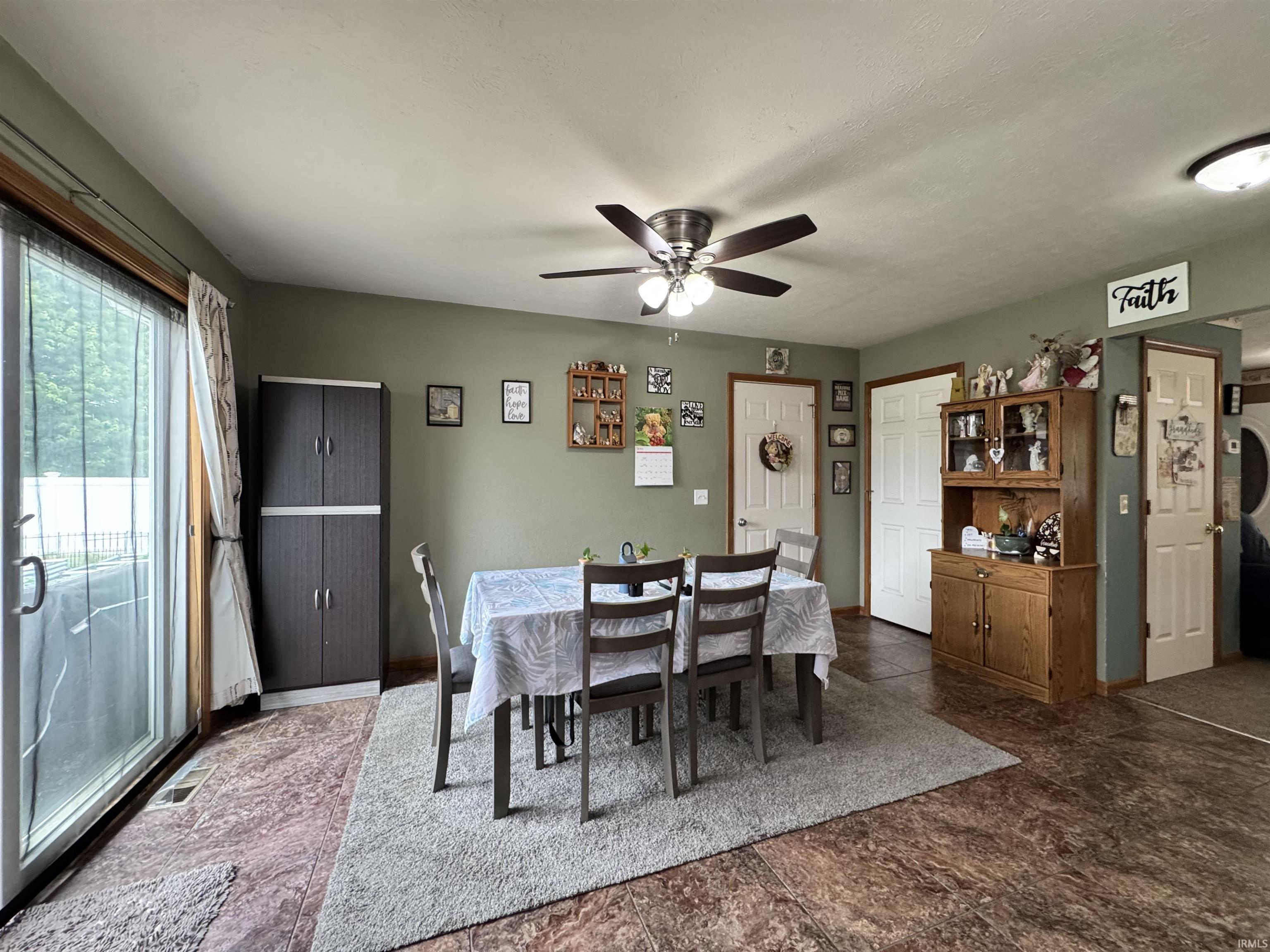 Dining area featuring warm-toned flooring and a neutral color palette