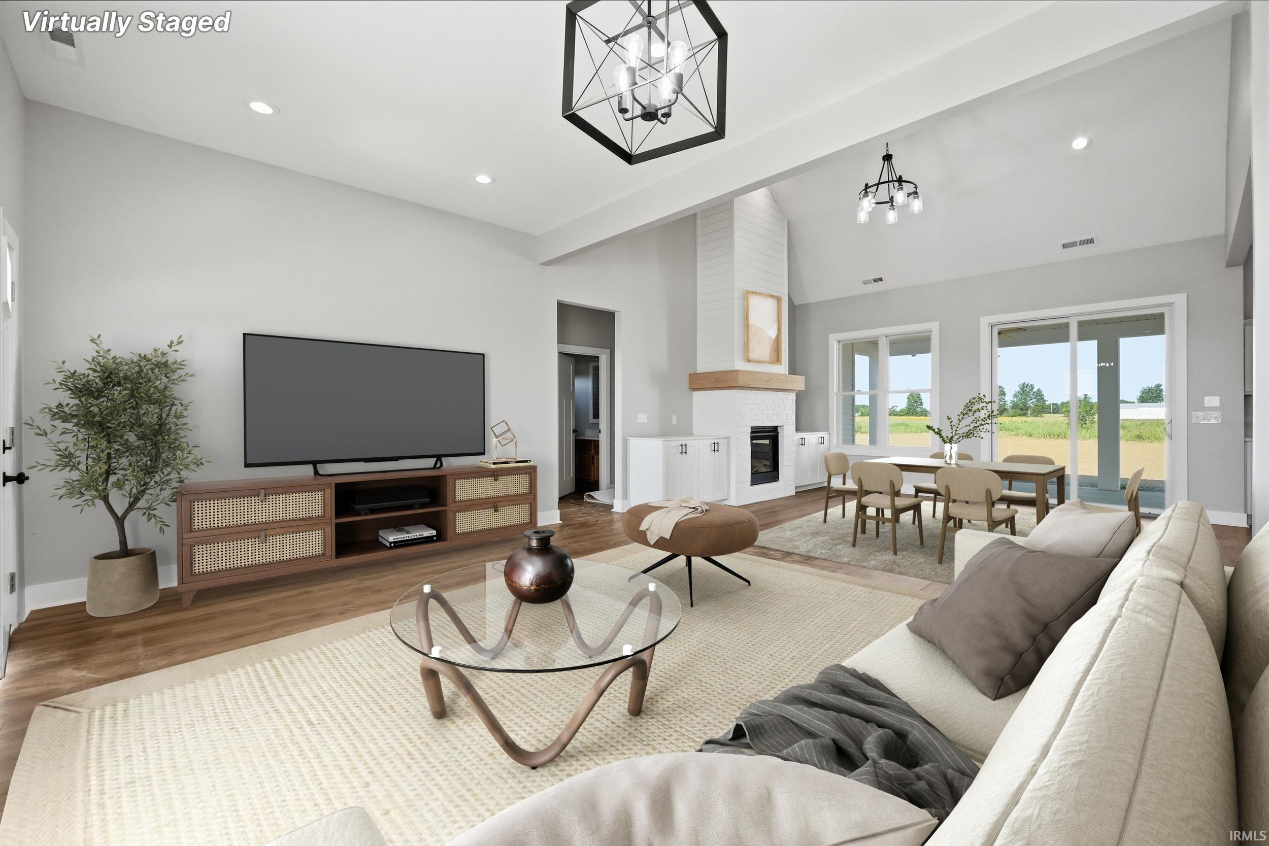 Spacious living area featuring vaulted ceilings, recessed lighting, and wood-finish flooring