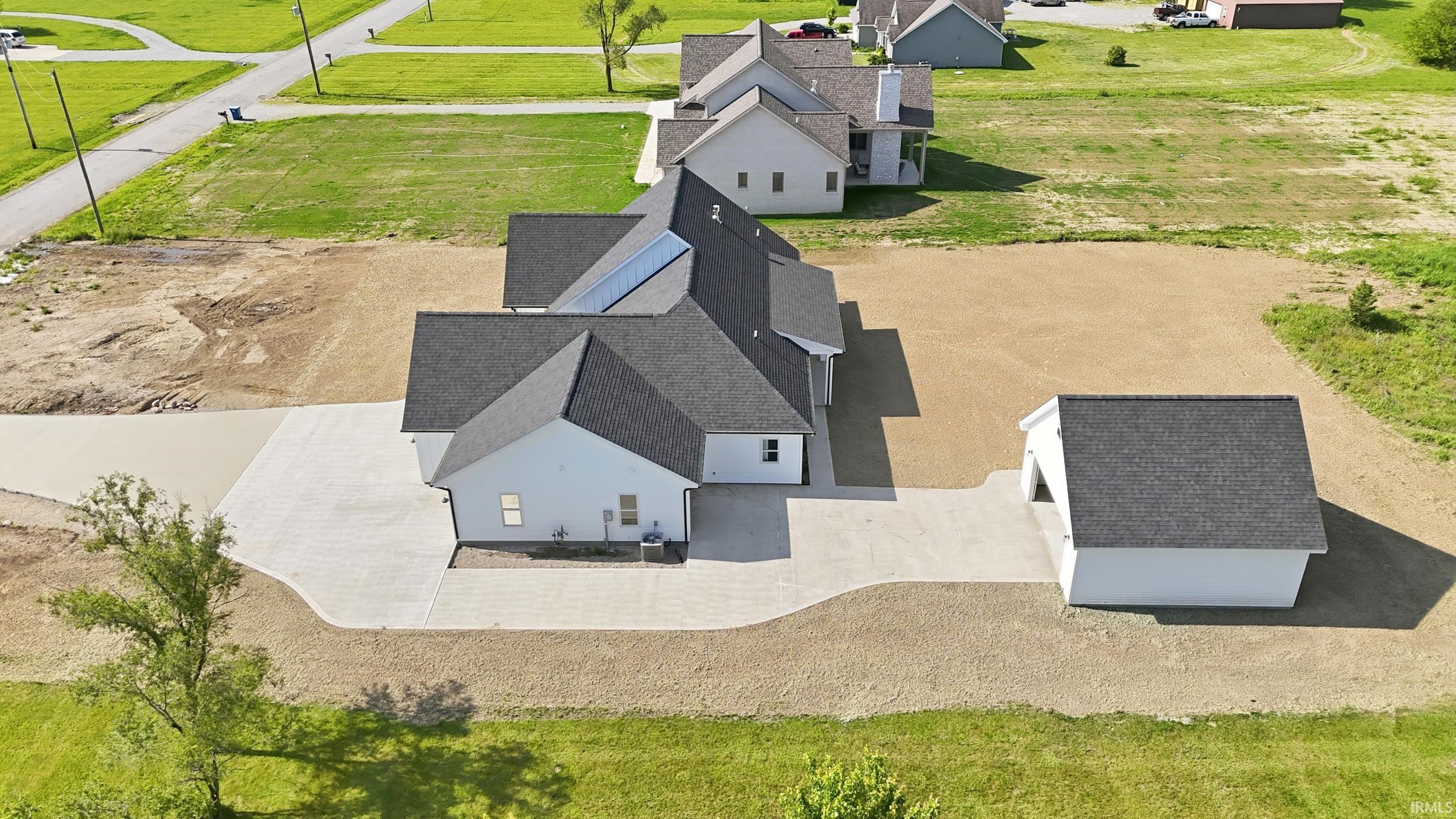Single-story residence featuring light-colored siding and a dark shingle roof