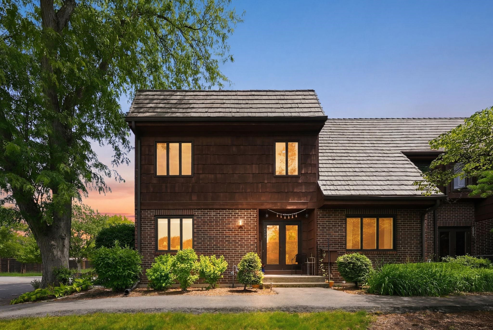 Brick and wood shake exterior featuring a multi-pane front entry door