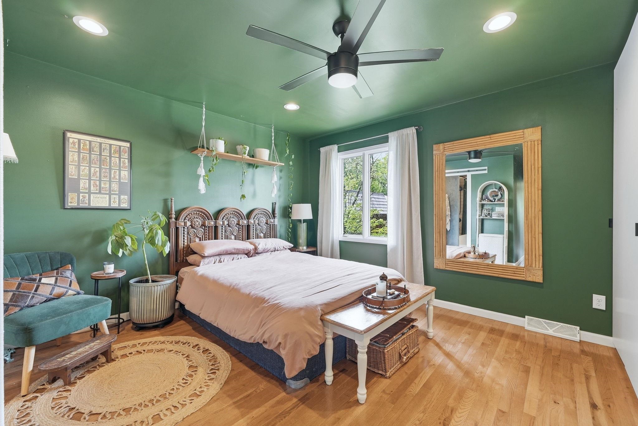 Bedroom featuring hardwood flooring, recessed lighting, a ceiling fan, and a window with exterior visibility