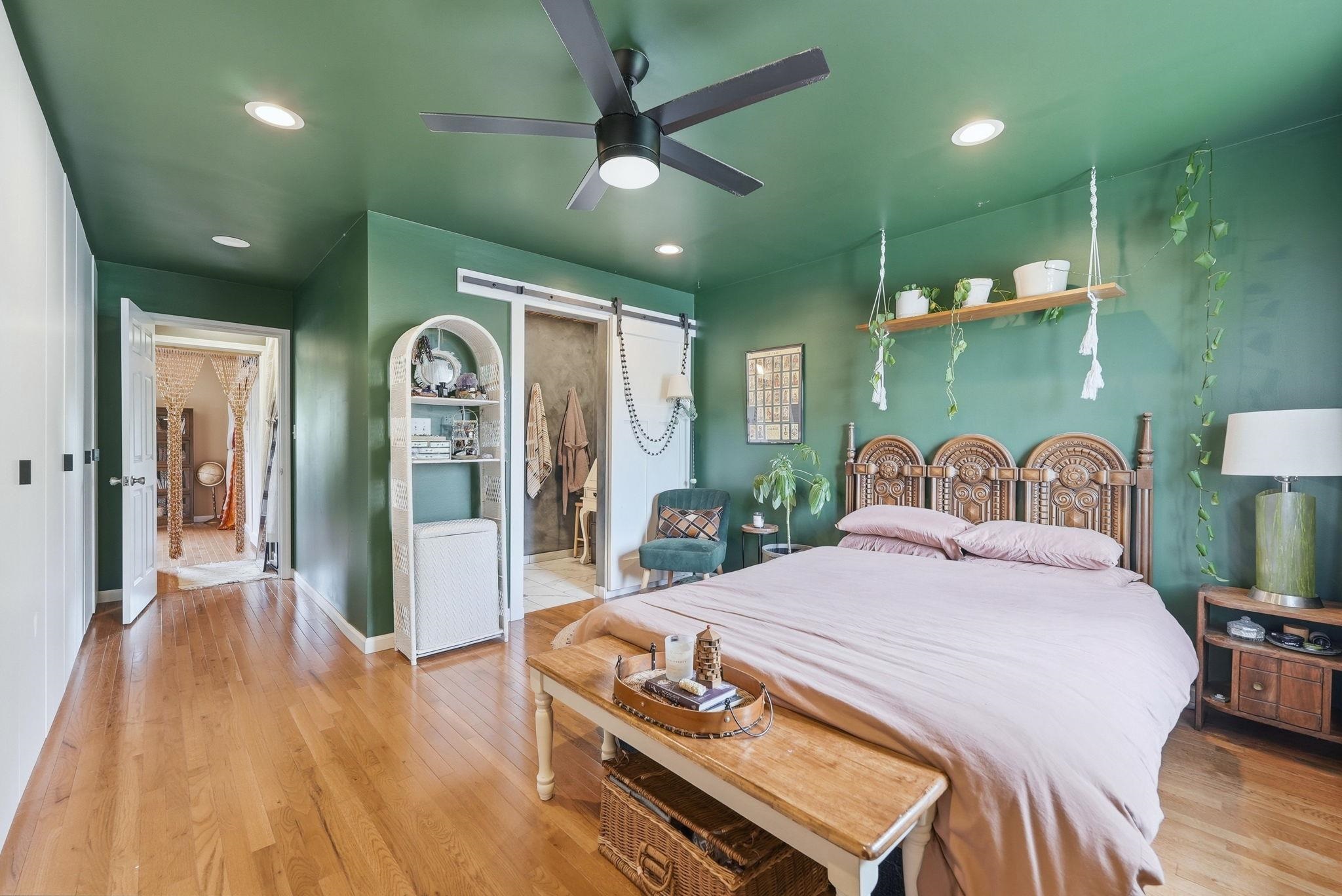 Warm wood-finish flooring complements a deep green wall and ceiling finish