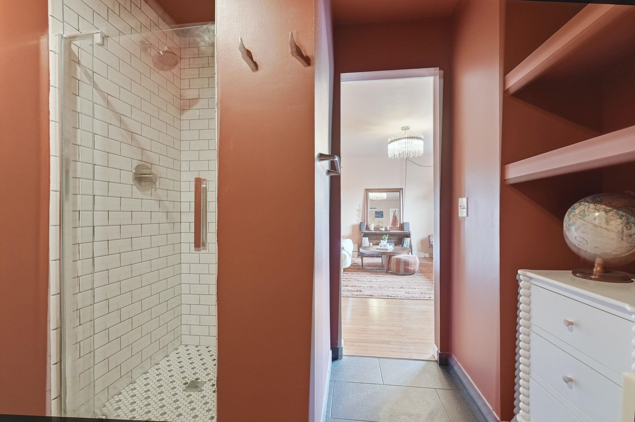 Walk-in shower with subway tile surround and mosaic tile floor