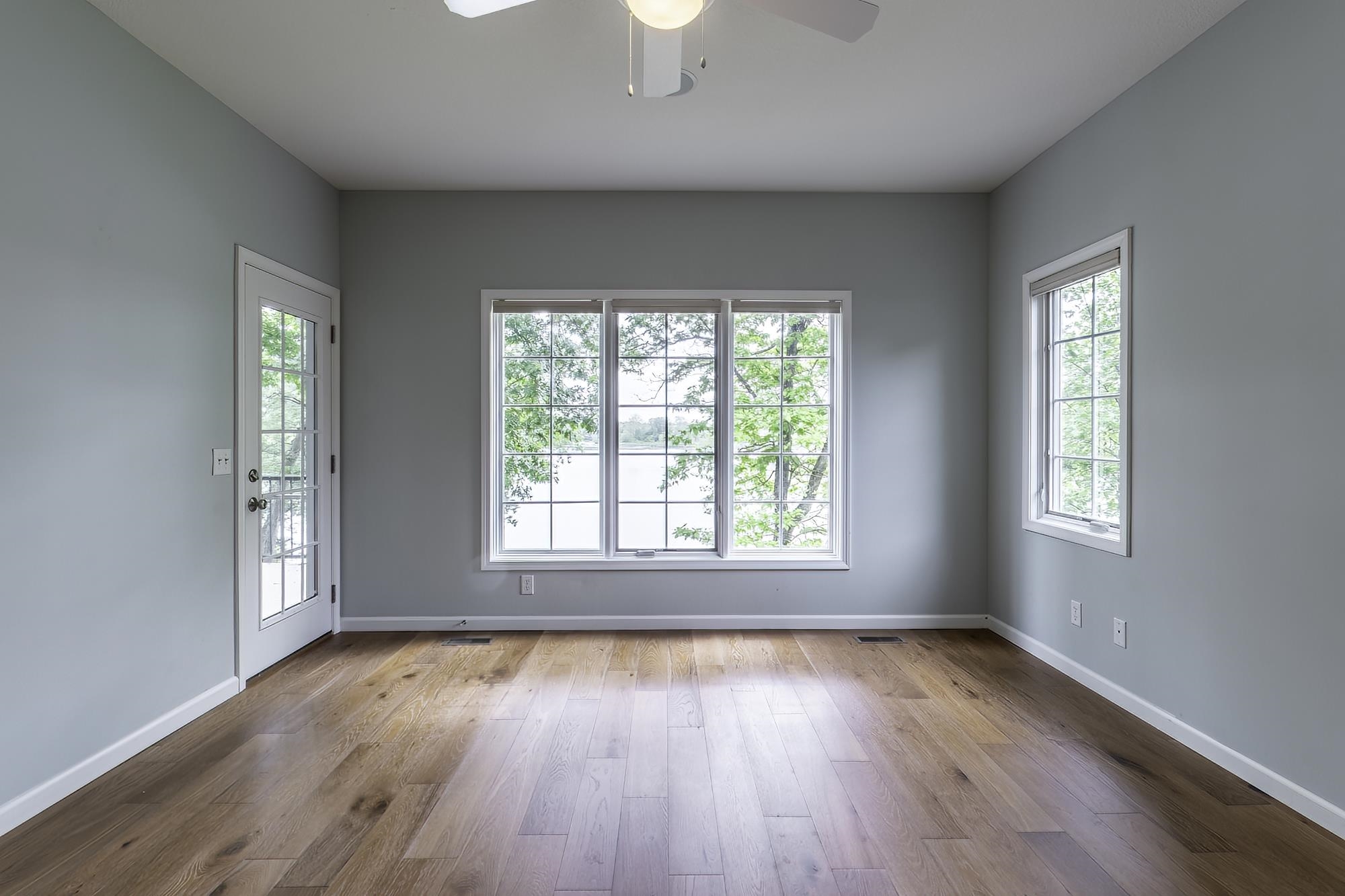 Hardwood-style flooring throughout this room with light gray walls and white trim