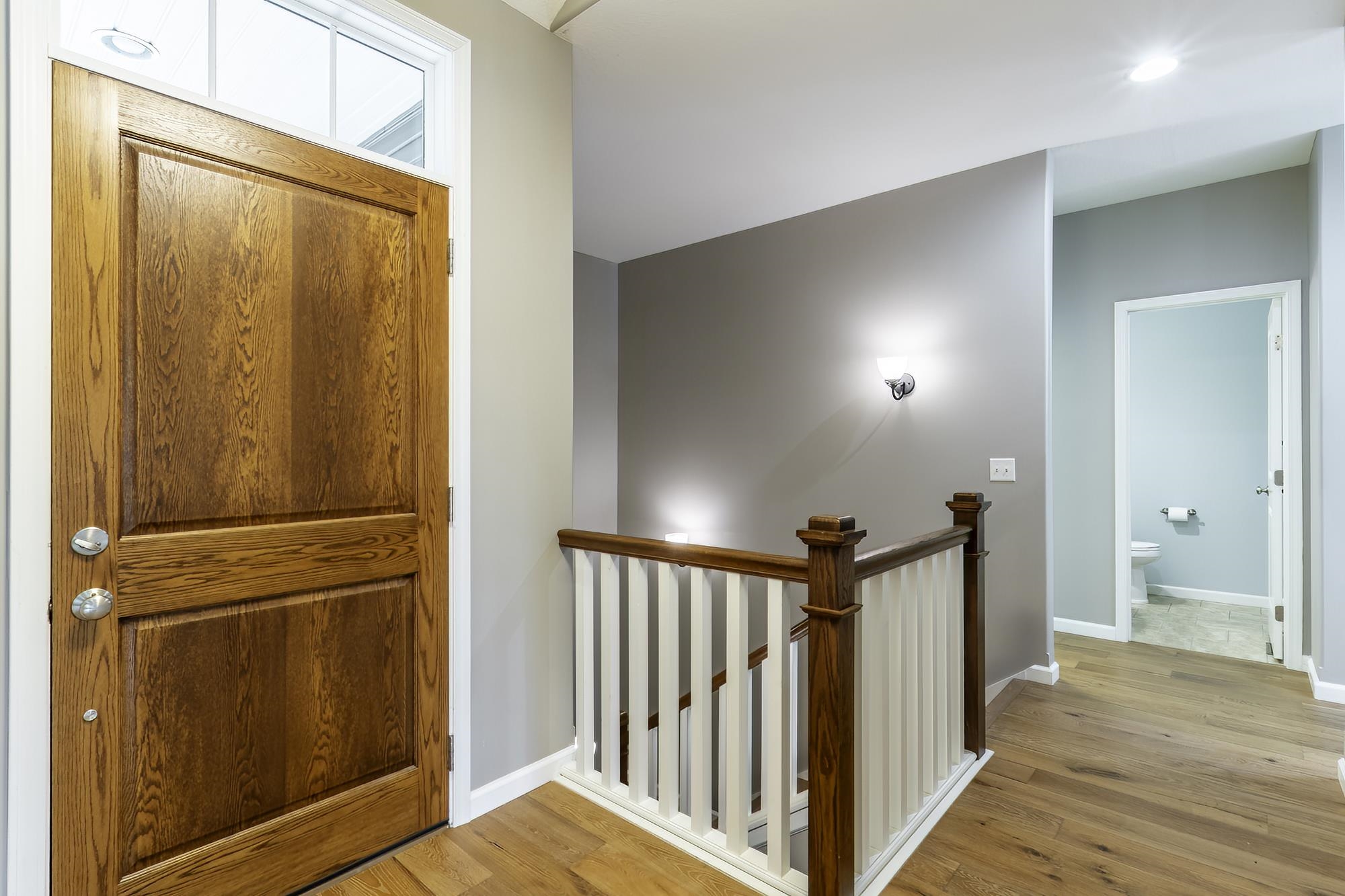 Wood-finish entry door with transom window