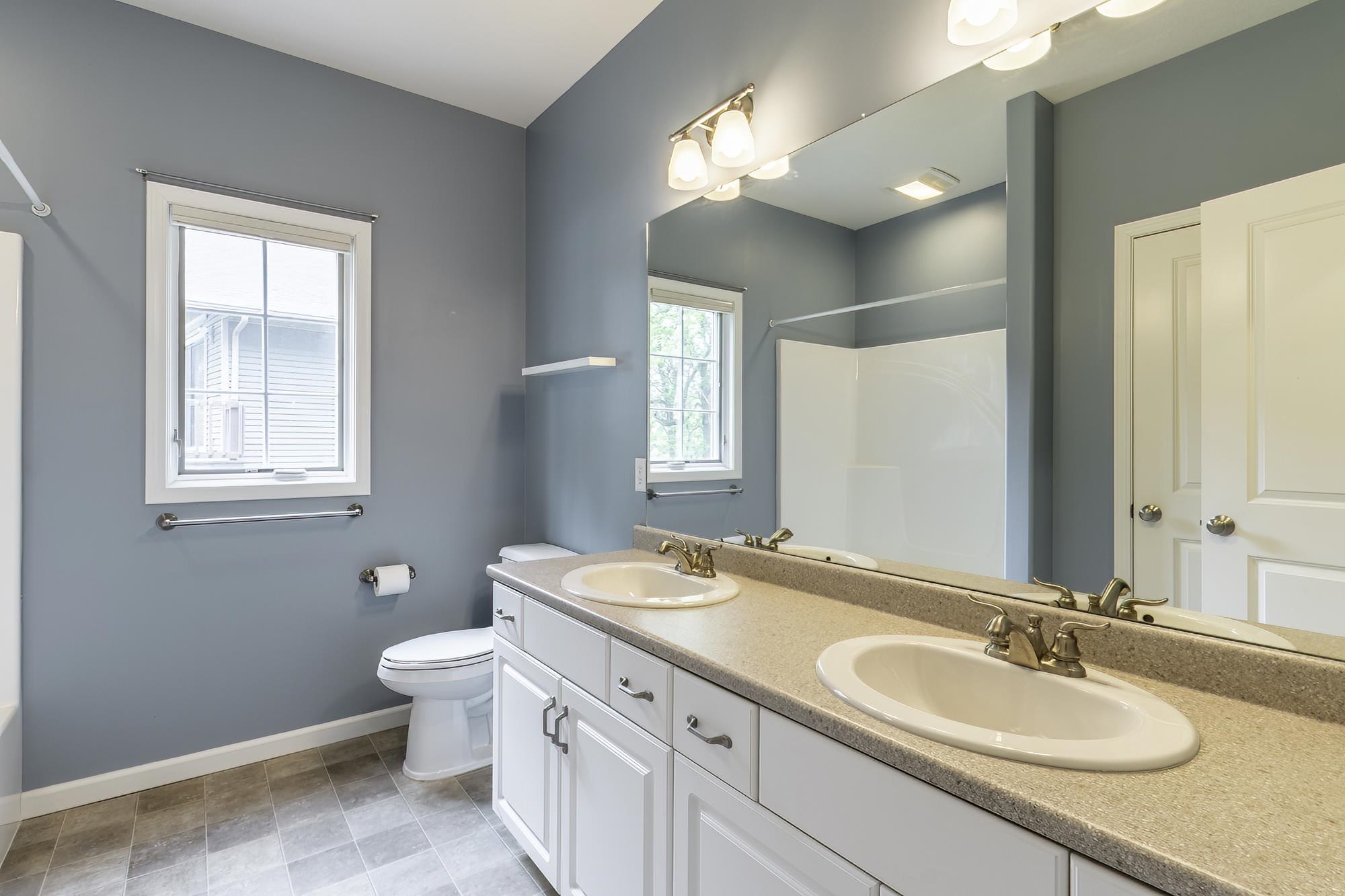 Dual vanity with white cabinetry and brushed nickel hardware