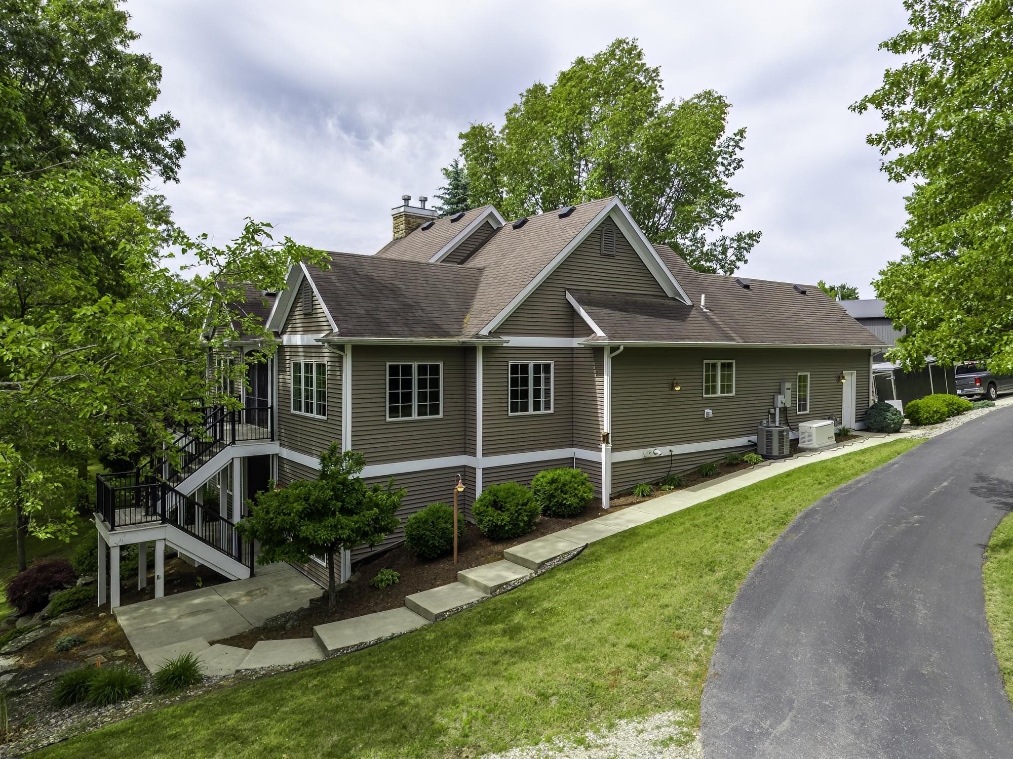 Two-story exterior with horizontal siding, multiple gables, and a shingle roof