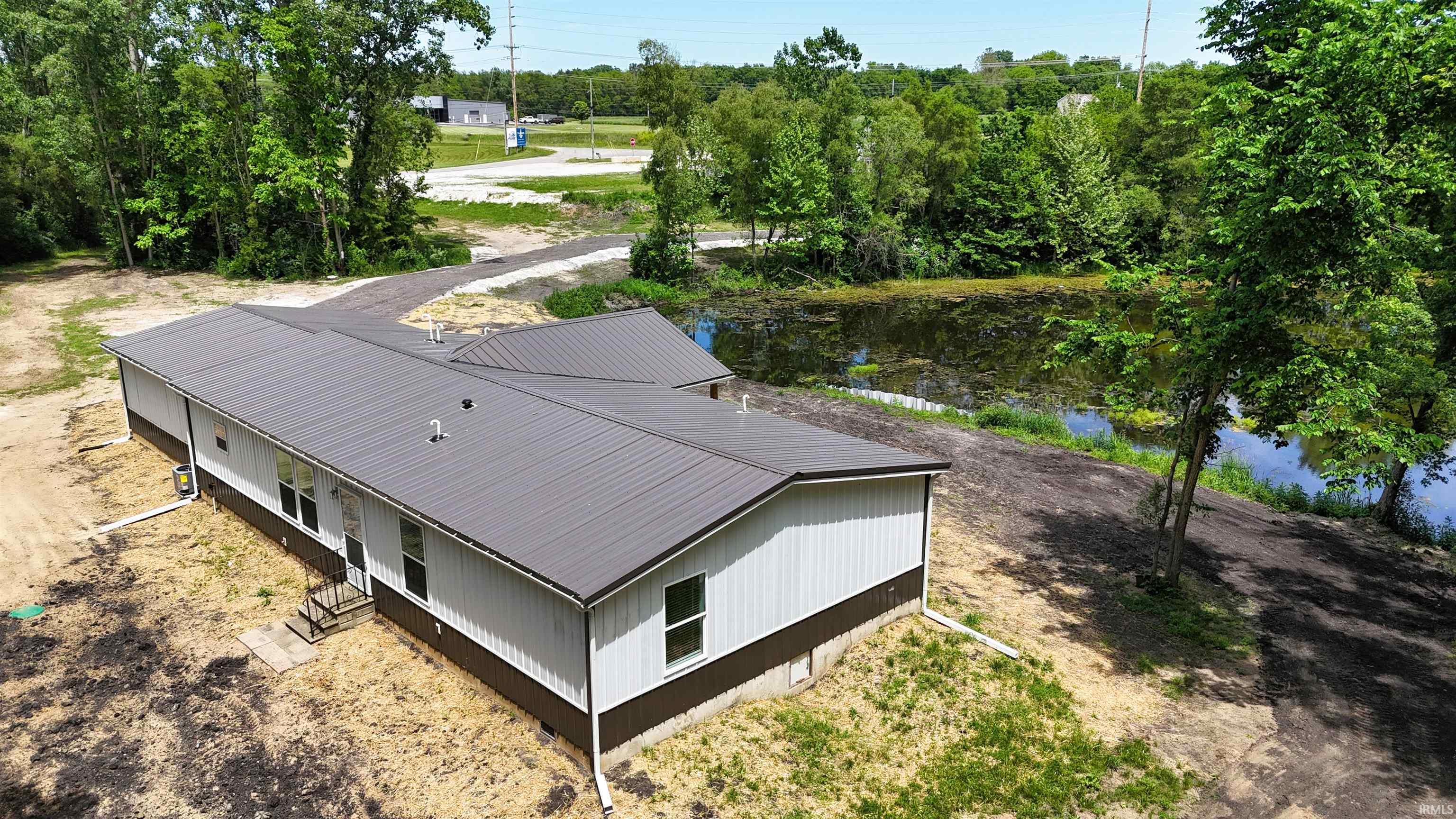 Single-story residence featuring a metal roof and two-tone exterior siding