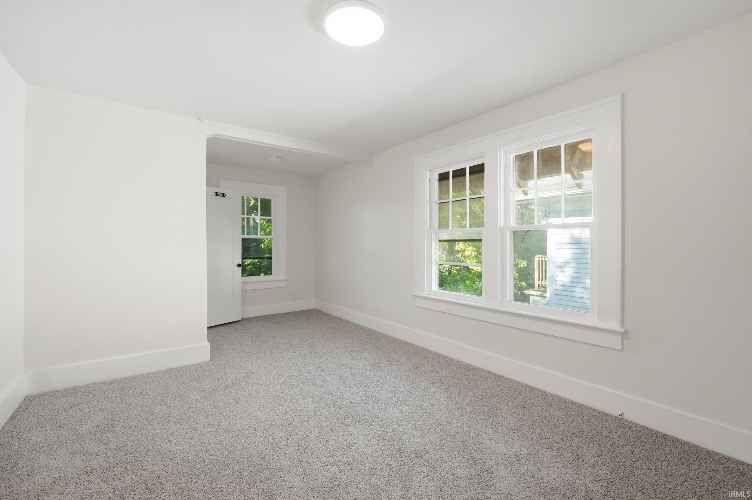 Bright interior space with light gray carpet and white walls