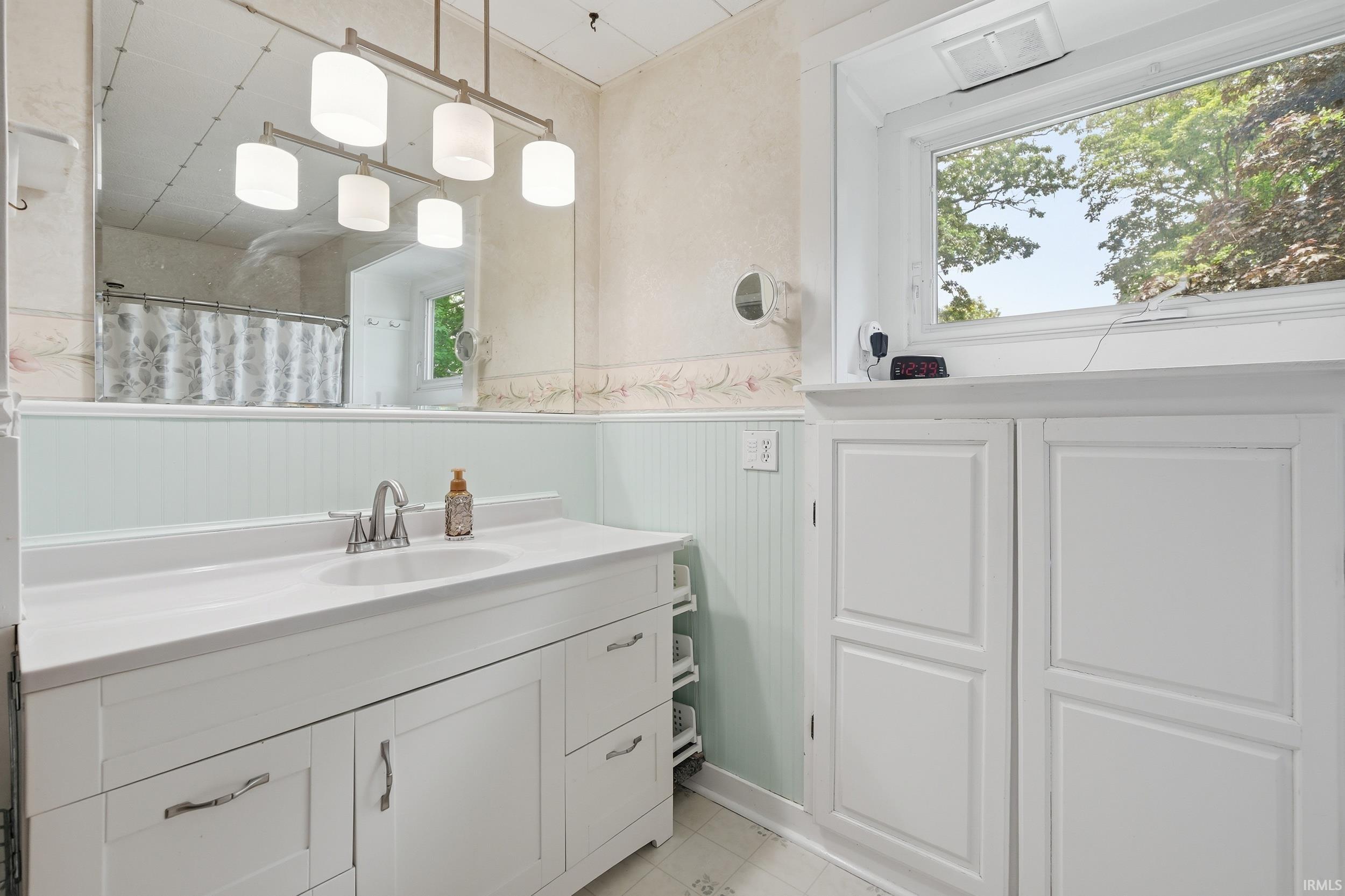 Vanity area with a white countertop and integrated sink