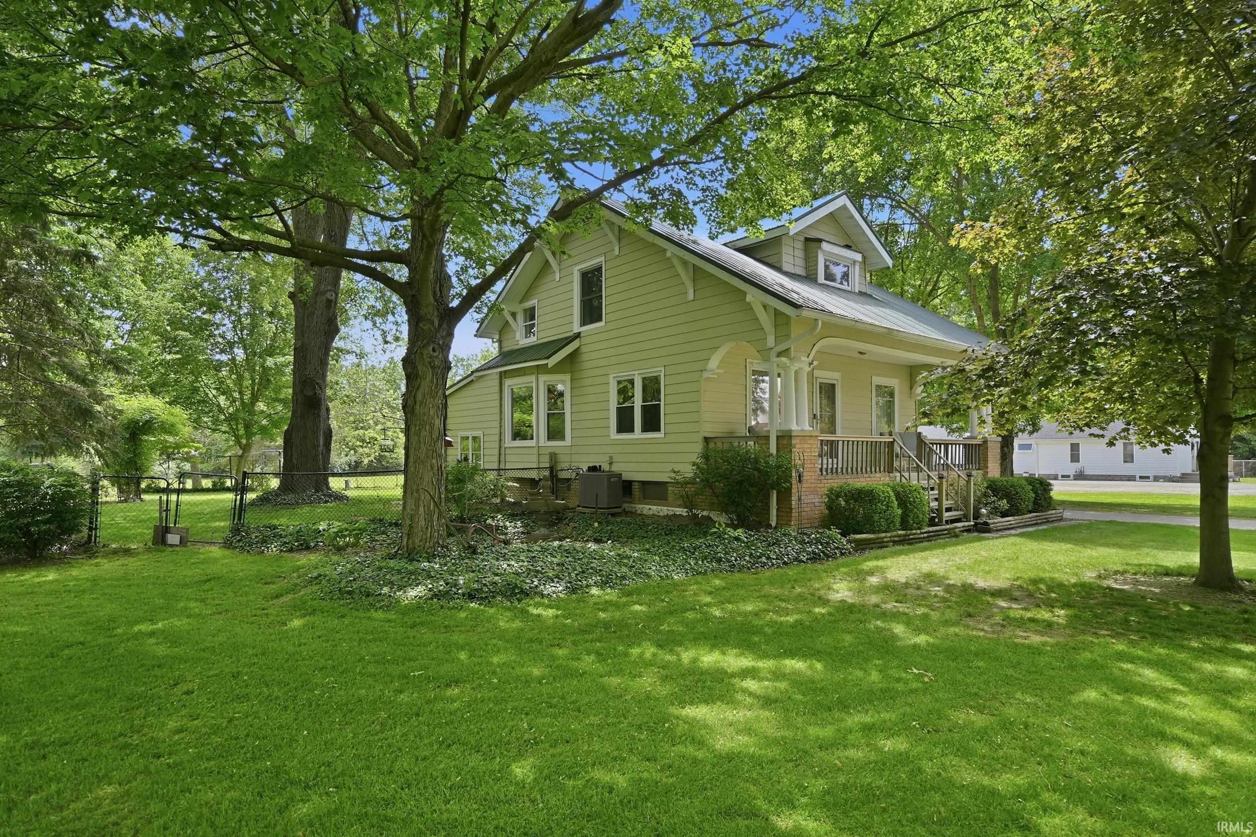 Traditional siding home with a covered front porch featuring decorative columns