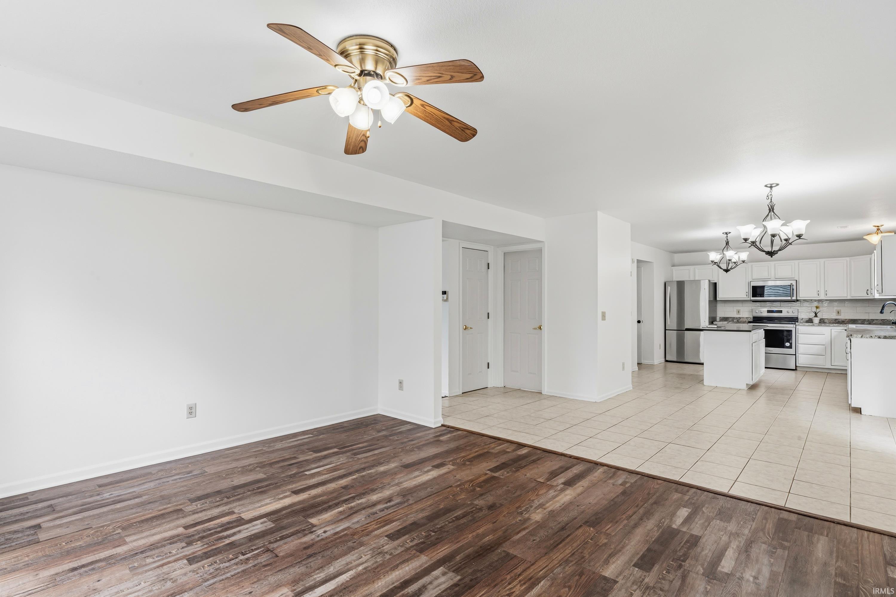 Open-concept living space featuring wood-finish flooring and a ceiling fan