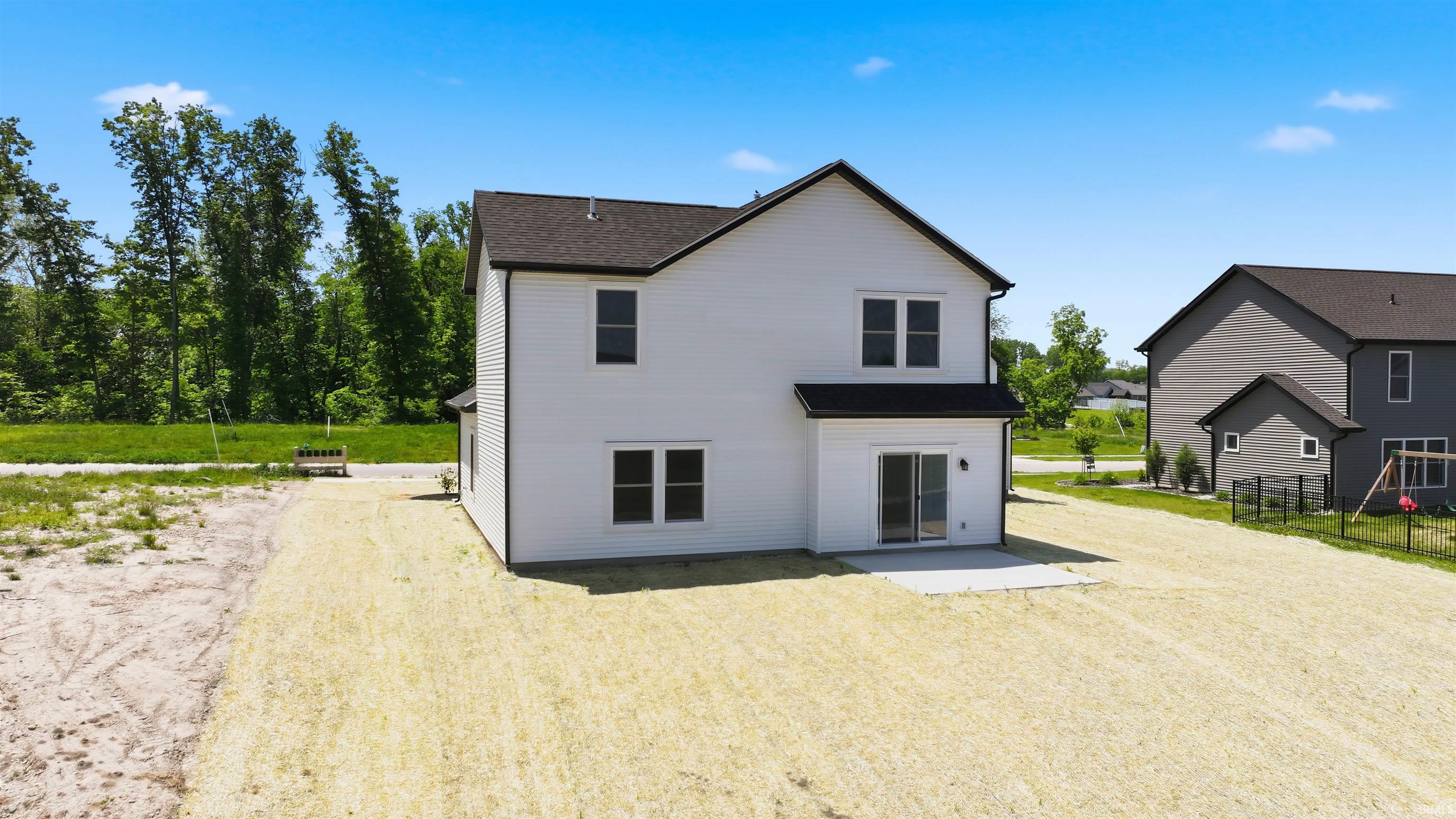 White exterior siding with black trim accents and a dark shingle roof