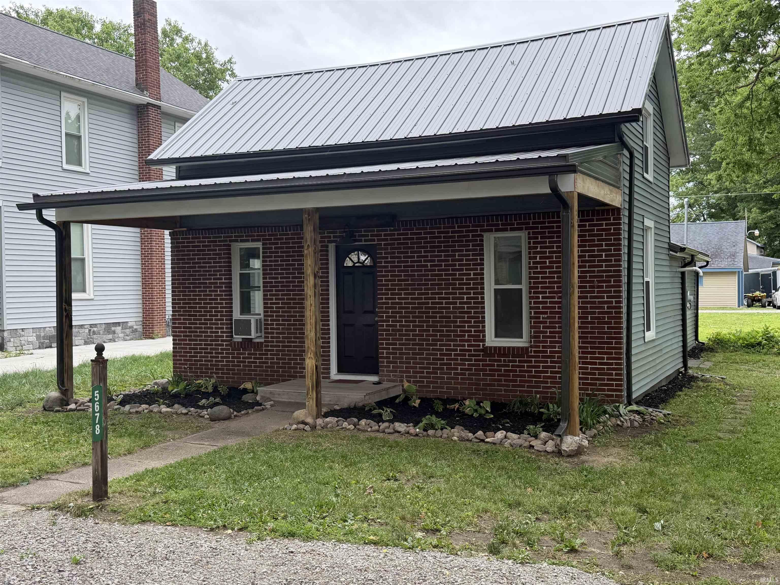 Property exterior featuring a mixed material facade with brick and horizontal siding