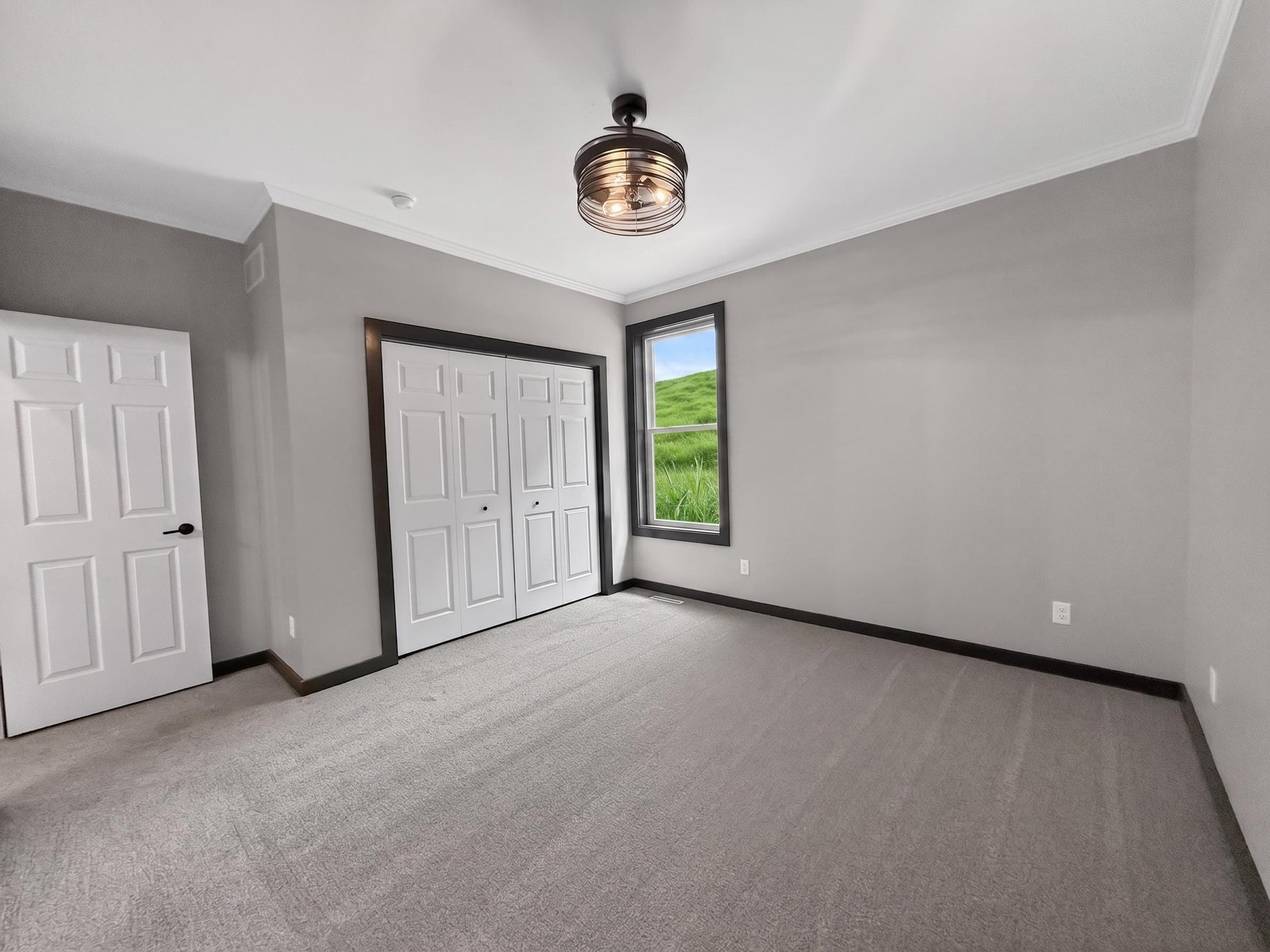 Room featuring neutral gray walls and light gray carpet