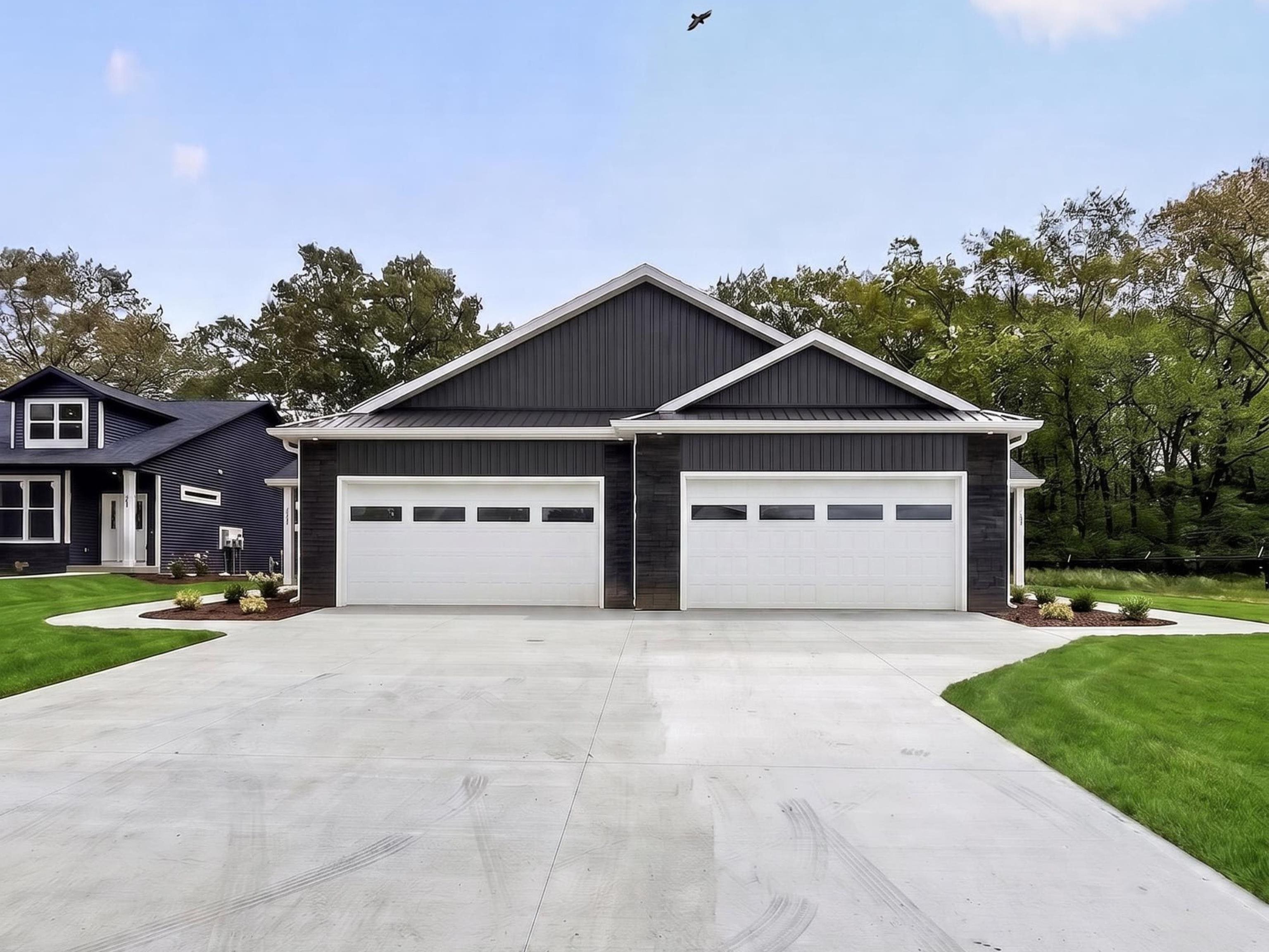 Contemporary exterior featuring dark vertical siding and white trim