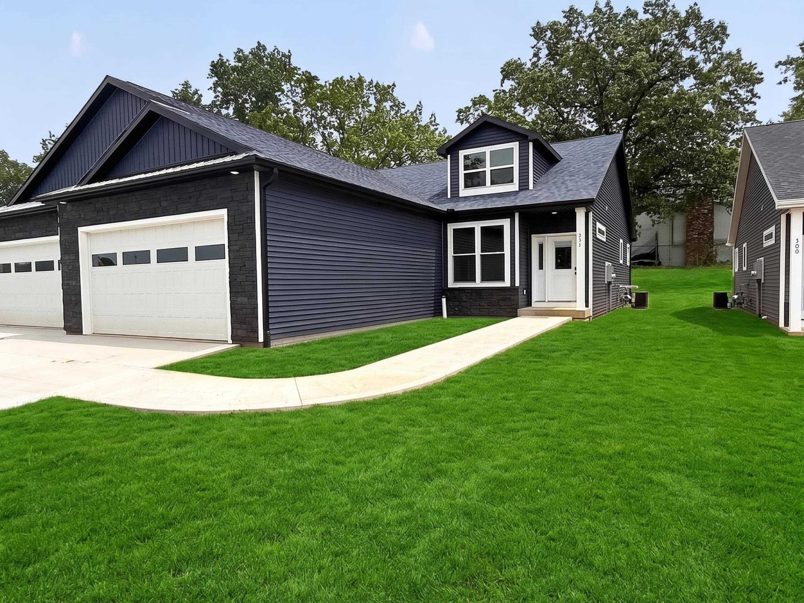 Modern exterior with dark horizontal siding, white trim, and a prominent dormer