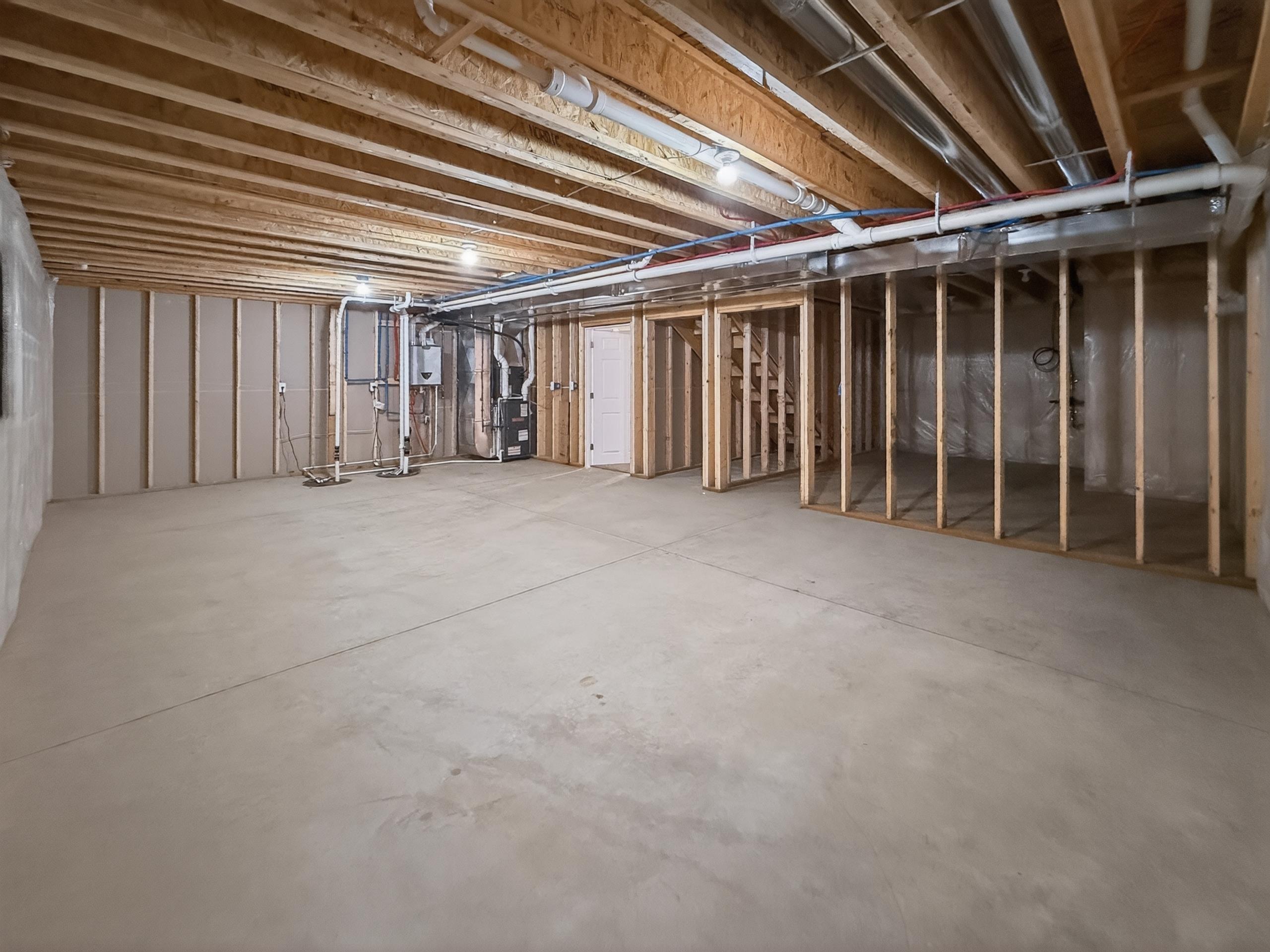 Unfinished basement featuring extensive open space and concrete flooring