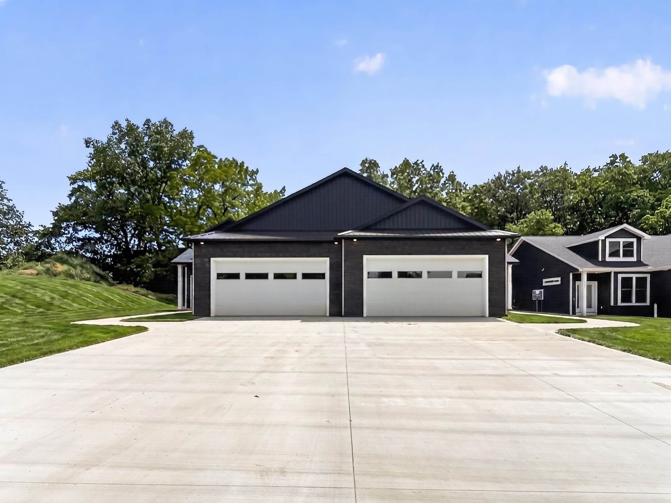 Two-car garage with contemporary white doors and frosted glass panels