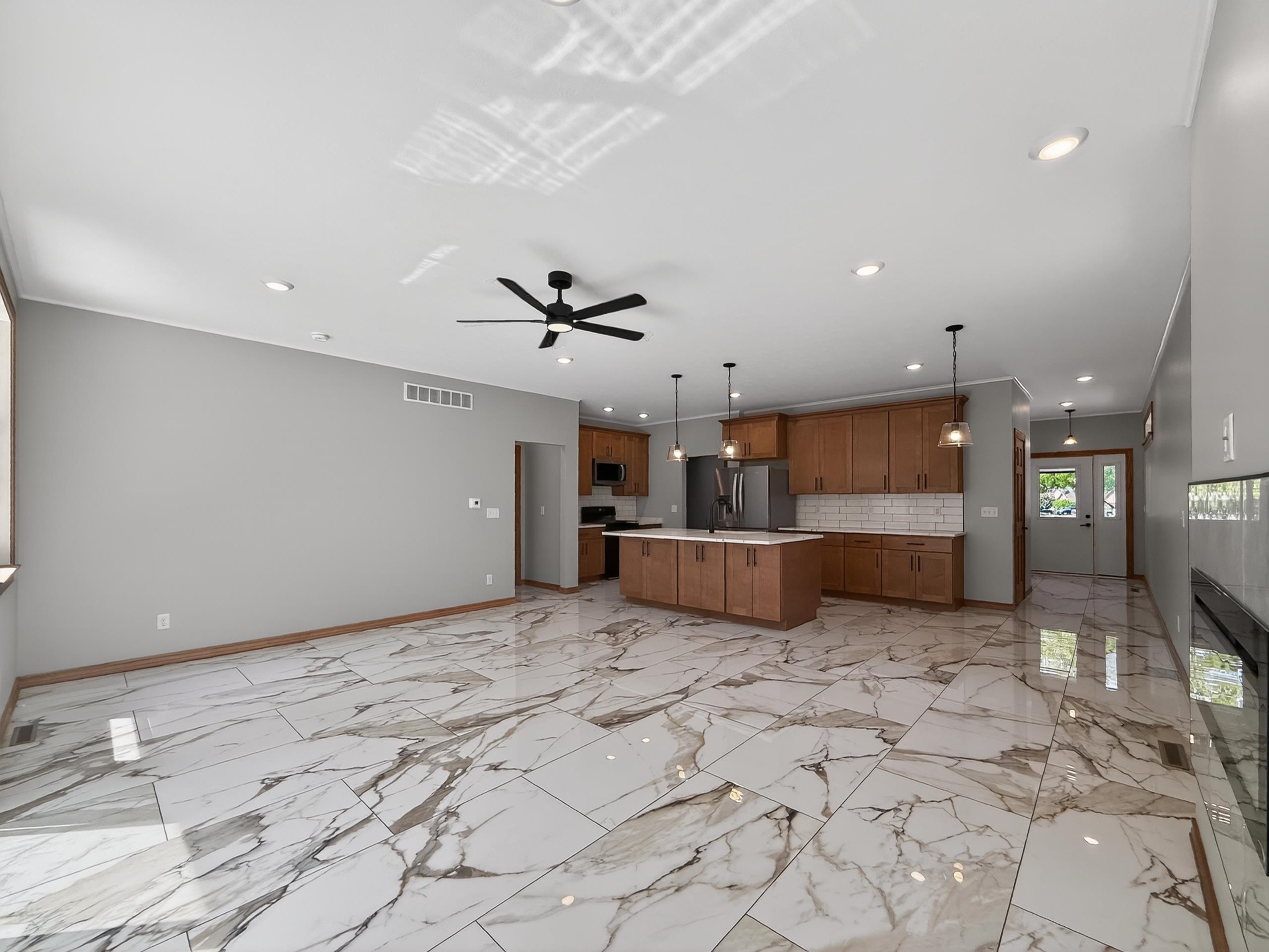 Open-concept living space with large format porcelain tile flooring