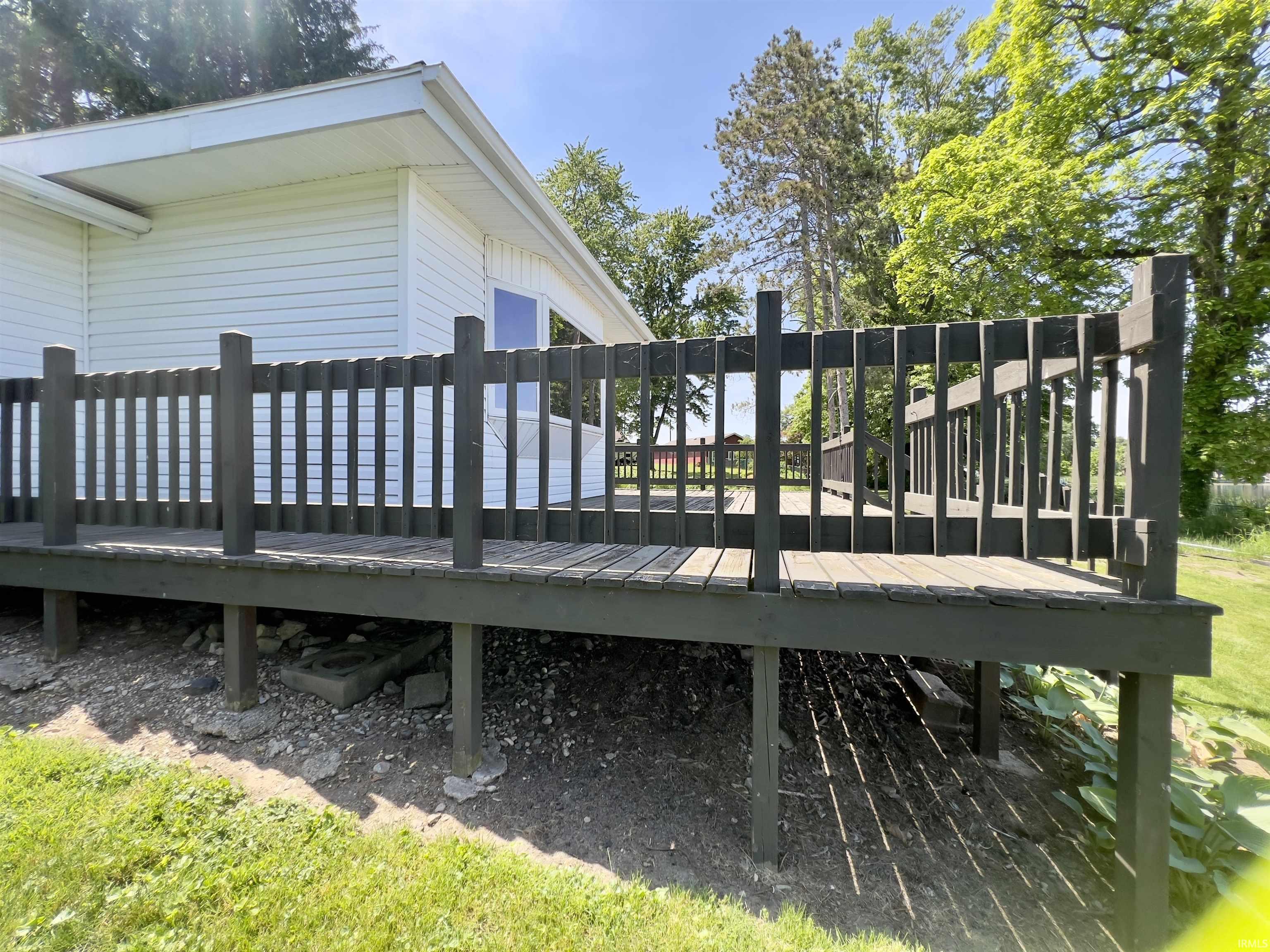 Spacious wood deck with dark-painted railing