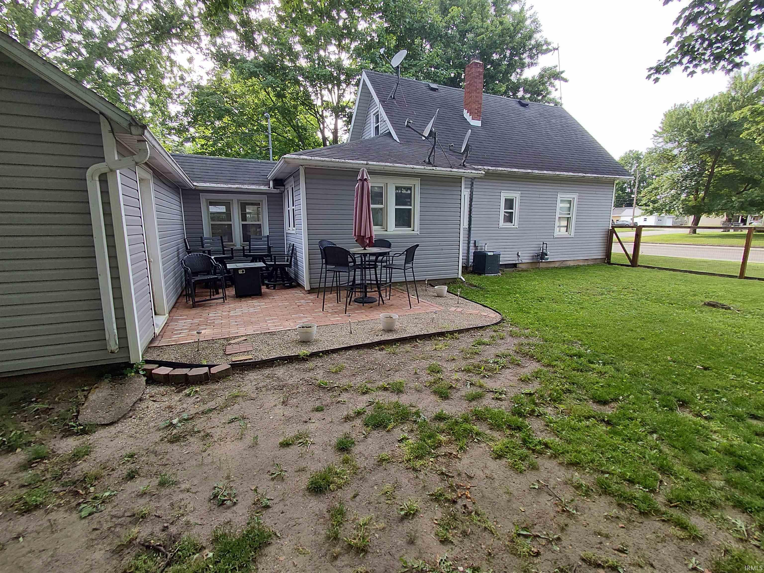 Exterior patio area featuring brick pavers and a perimeter border