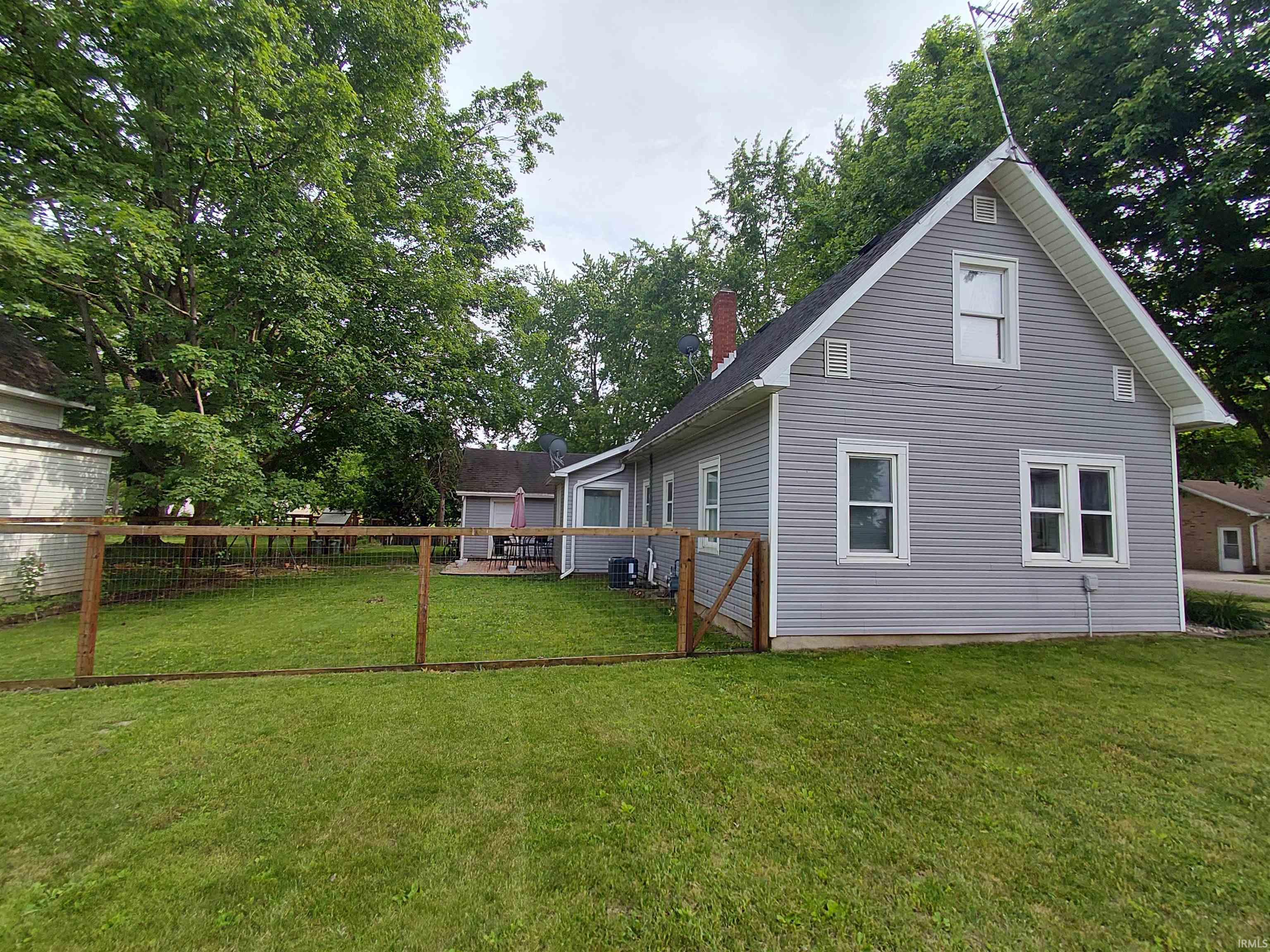 Gray siding residential structure with an A-frame roofline and white trim