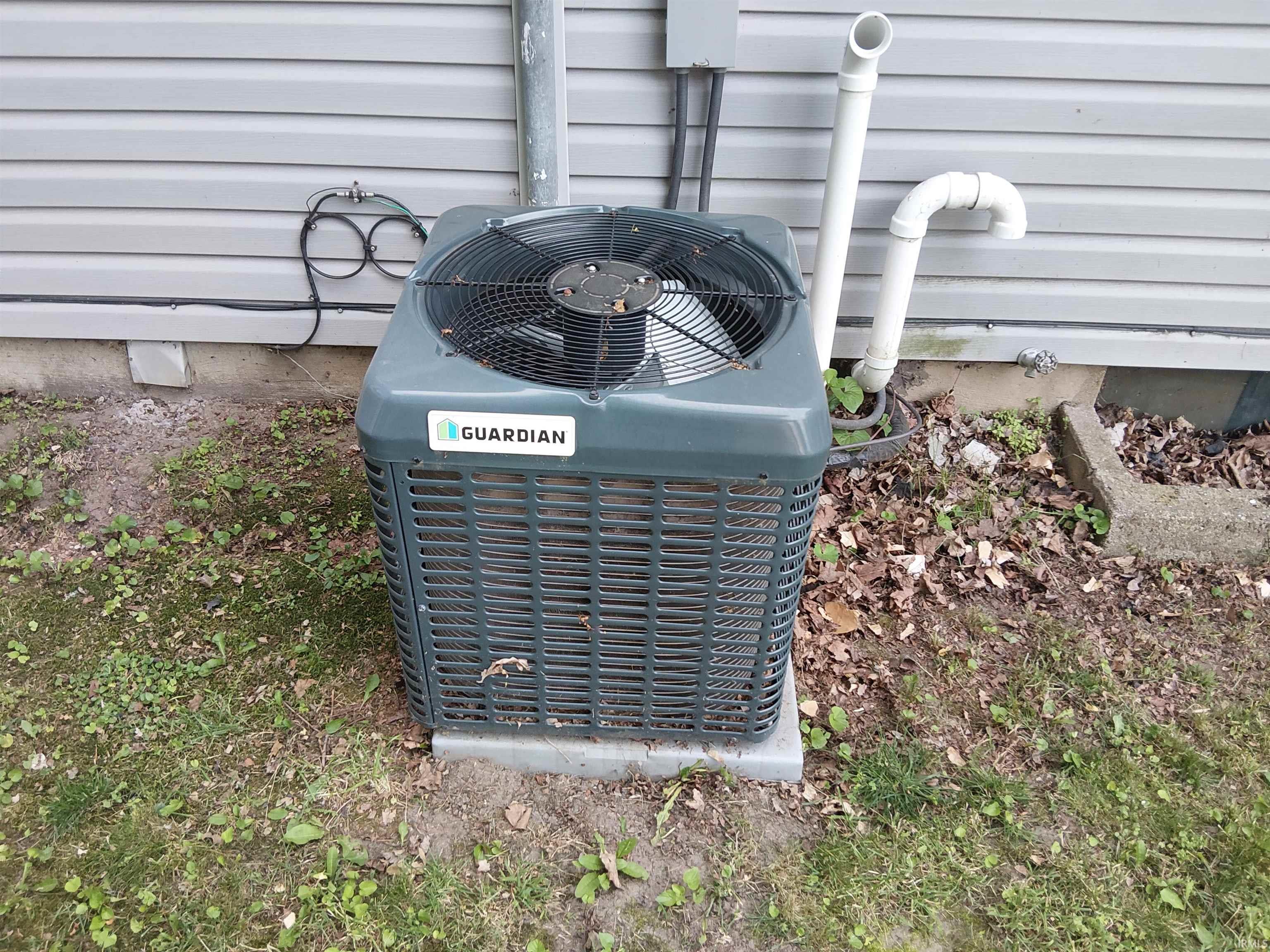 Guardian brand outdoor air conditioning unit on a concrete pad