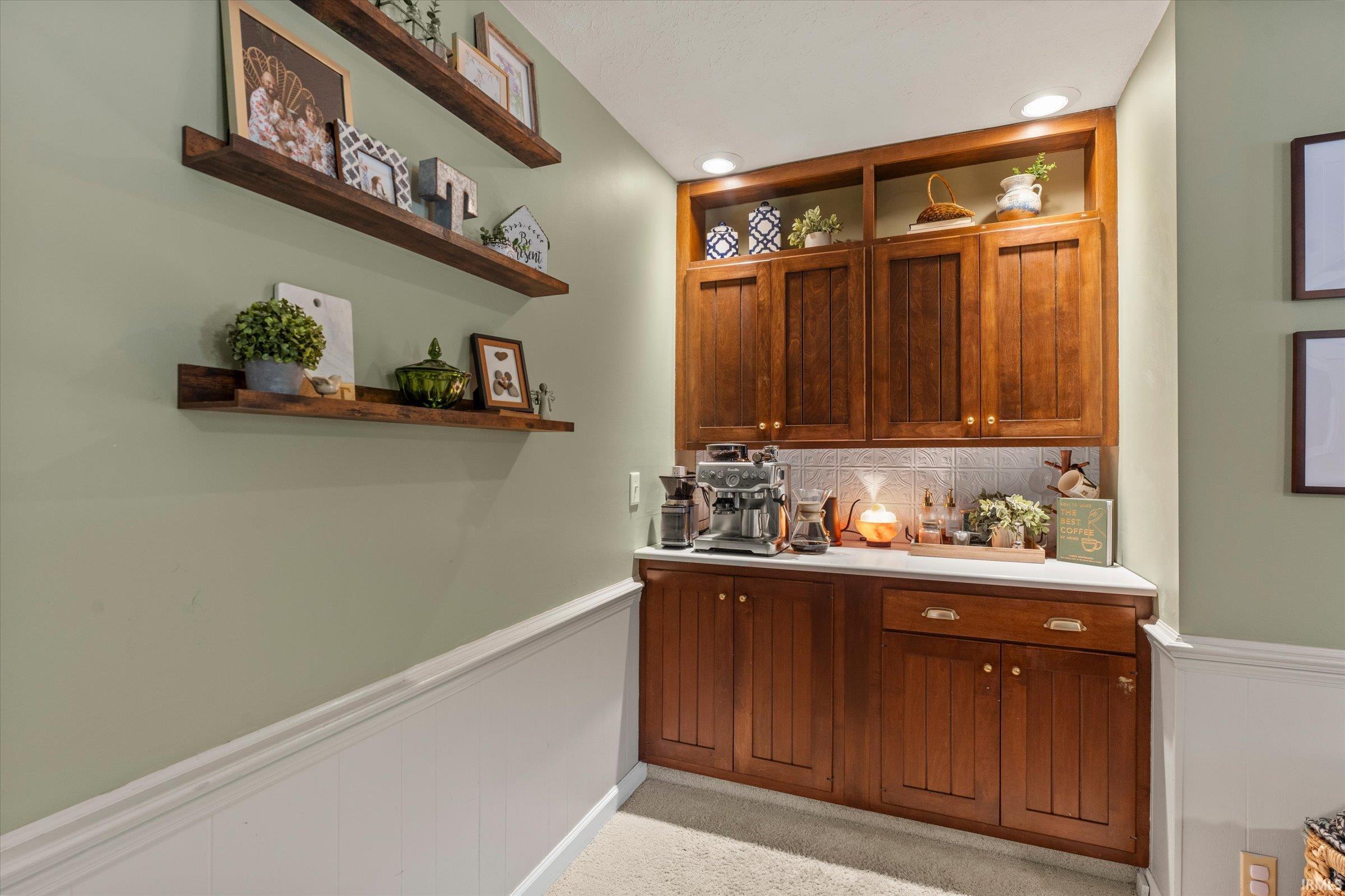 Built-in cabinetry featuring rich wood-finish doors and brass hardware