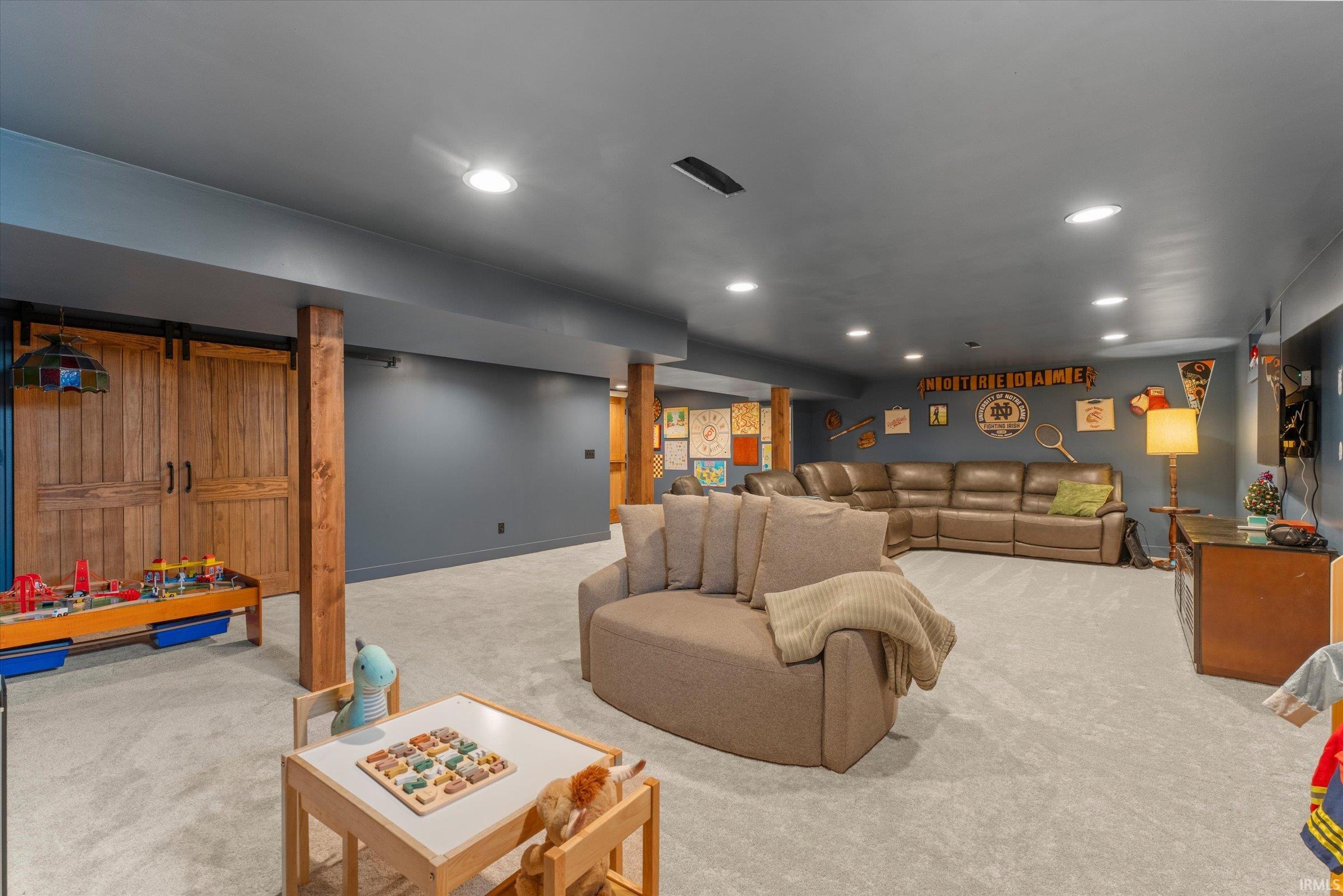 Spacious finished room with recessed lighting and neutral carpet flooring