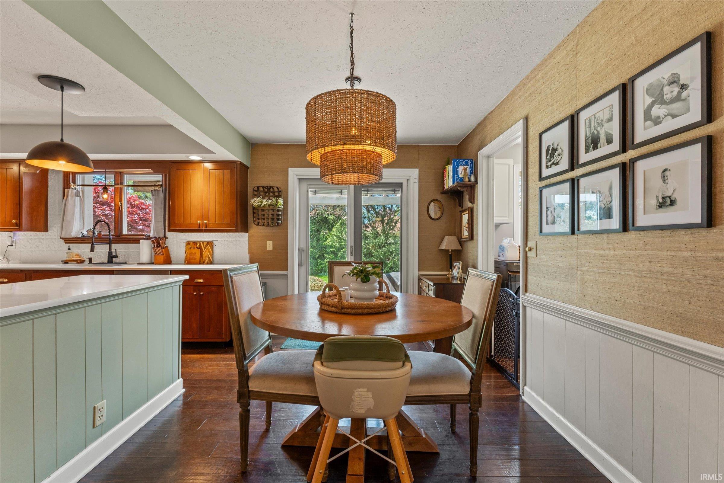 Dining area with a natural wood-finish table and woven pendant lighting
