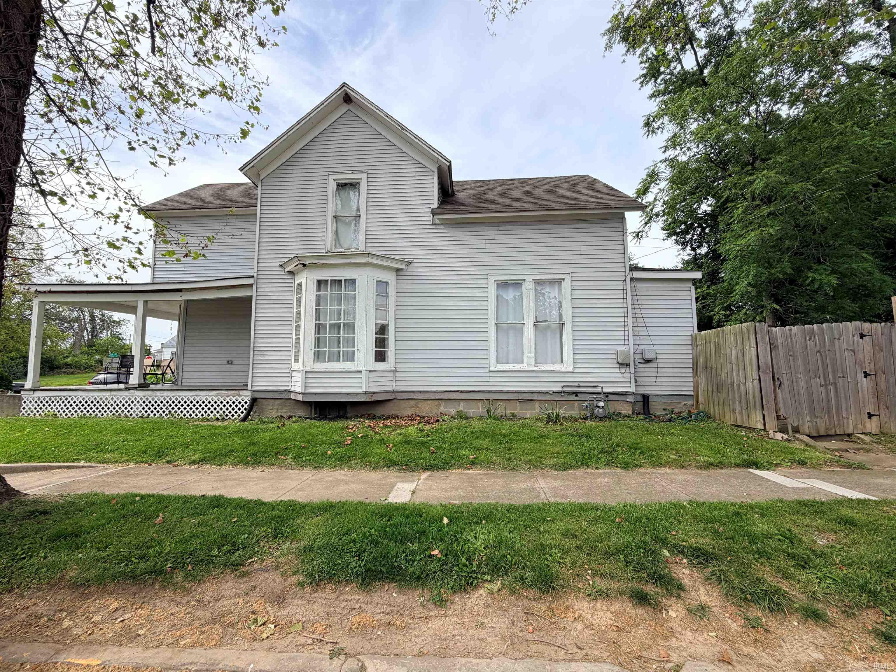 White siding exterior featuring a prominent bay window