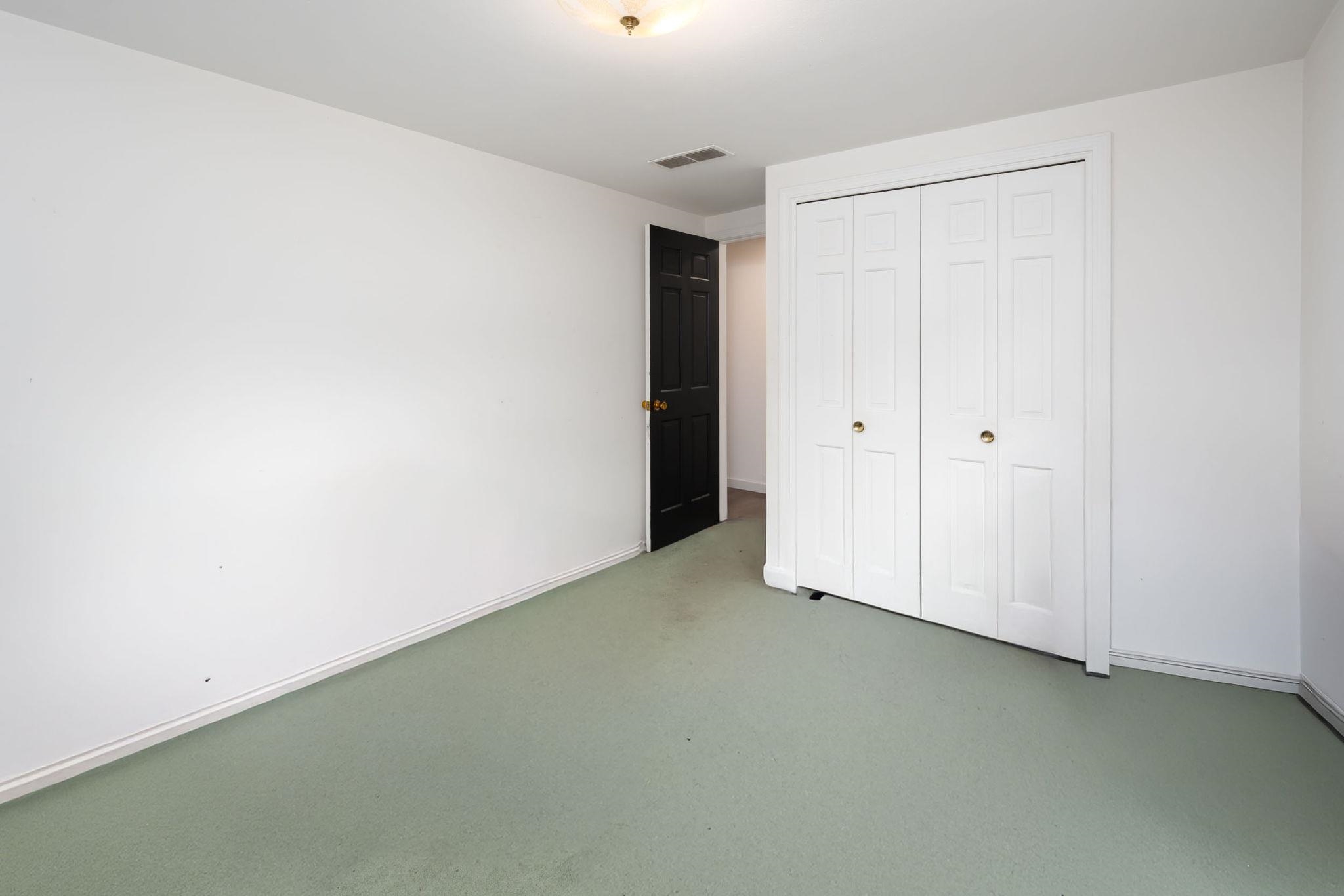 Room featuring light green carpeting and white painted walls