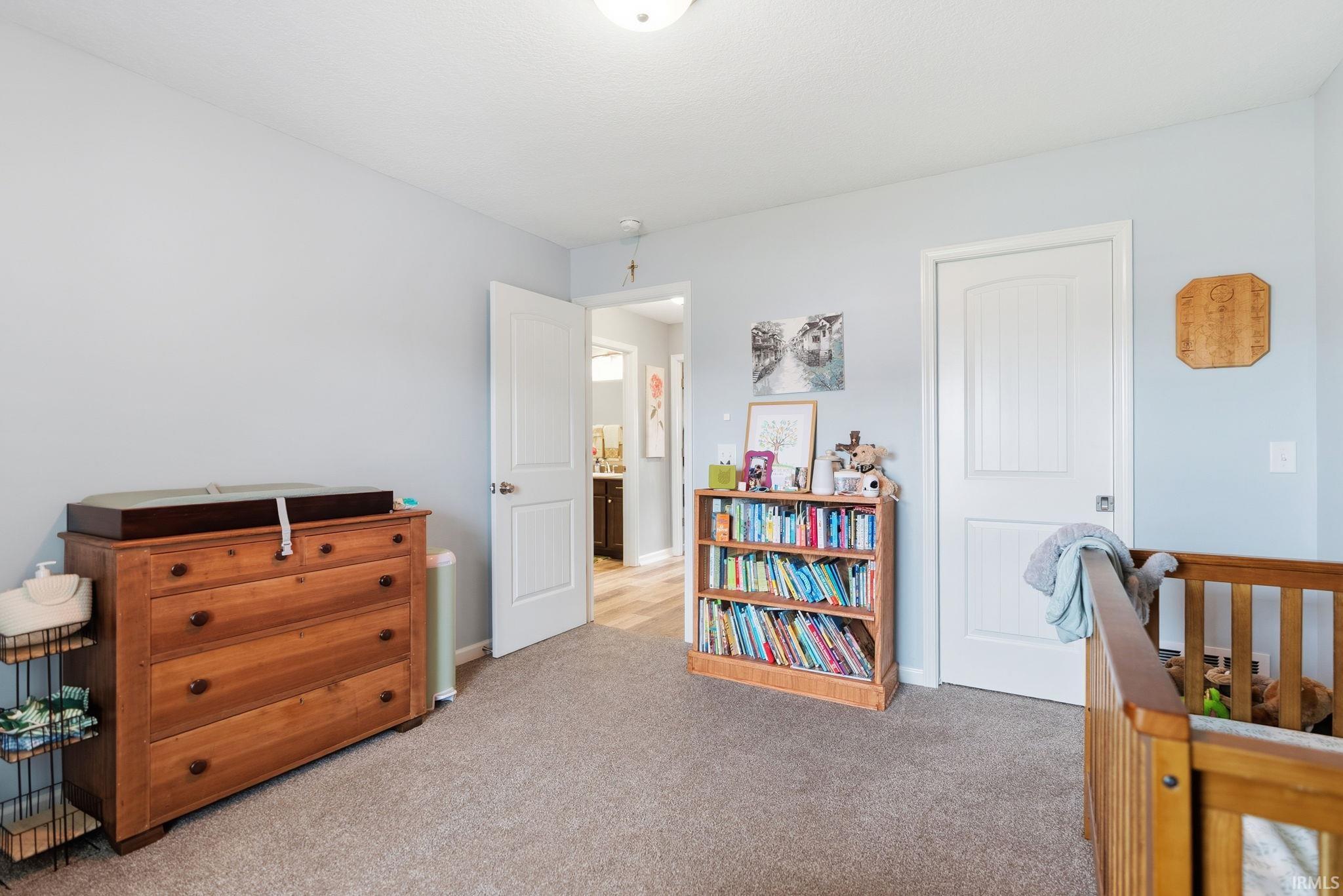 Carpeted room with a light blue wall finish