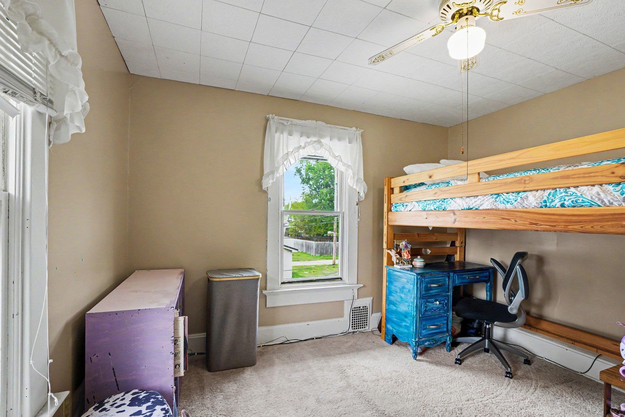 Neutral-toned walls complement the light-colored carpet flooring