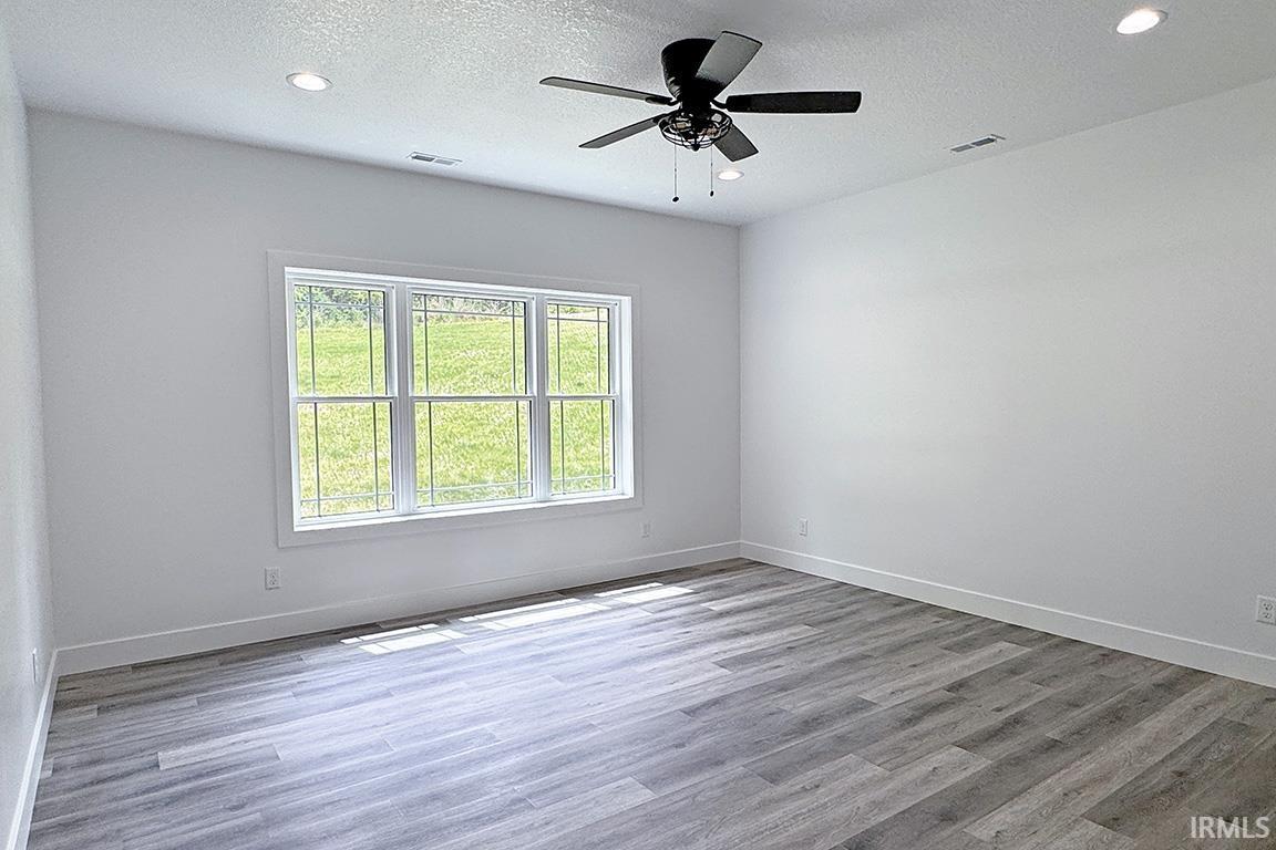Bright room featuring light wood-finish flooring and a multi-pane window