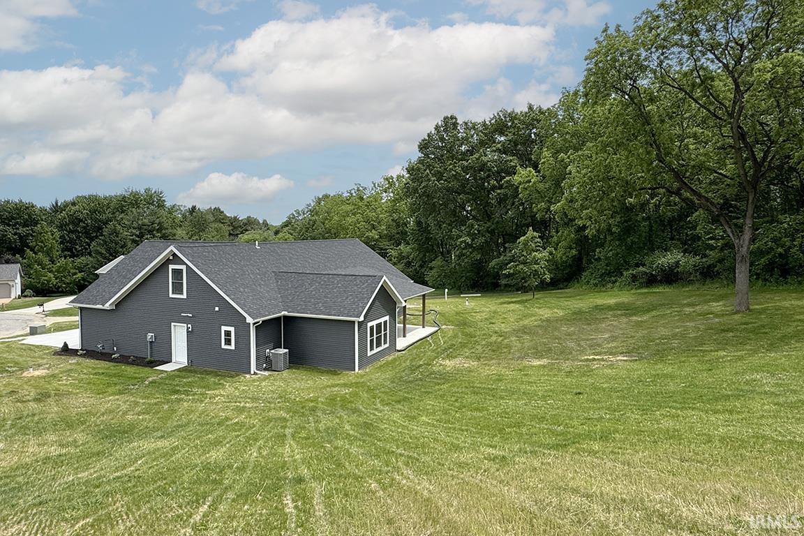 Modern residence featuring dark gray siding and a contrasting white trim