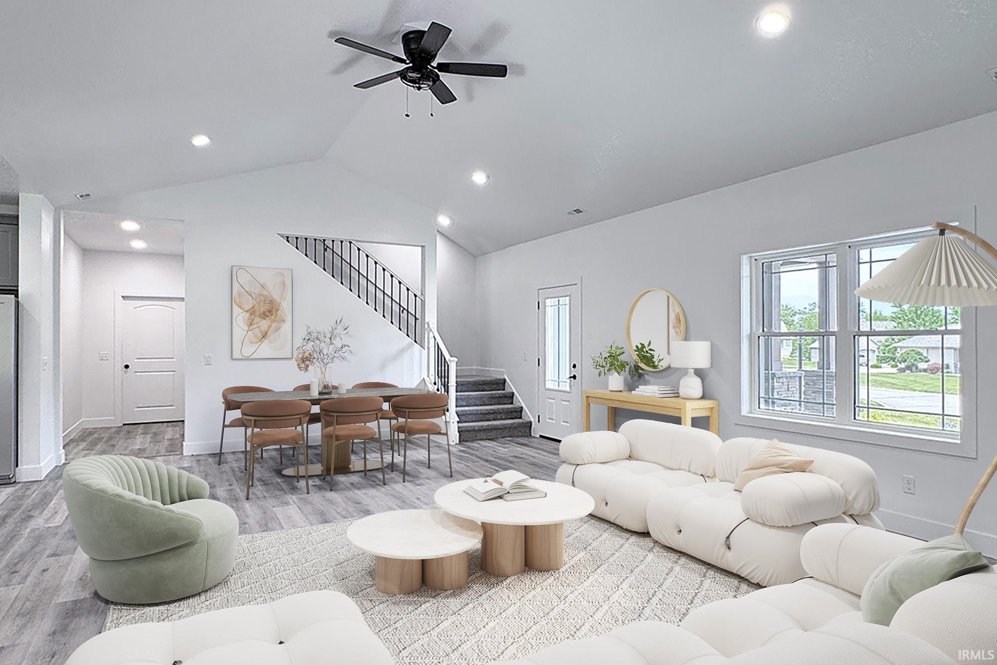 Open-concept living space featuring wood-finish flooring, recessed lighting, a modern ceiling fan, and large windows