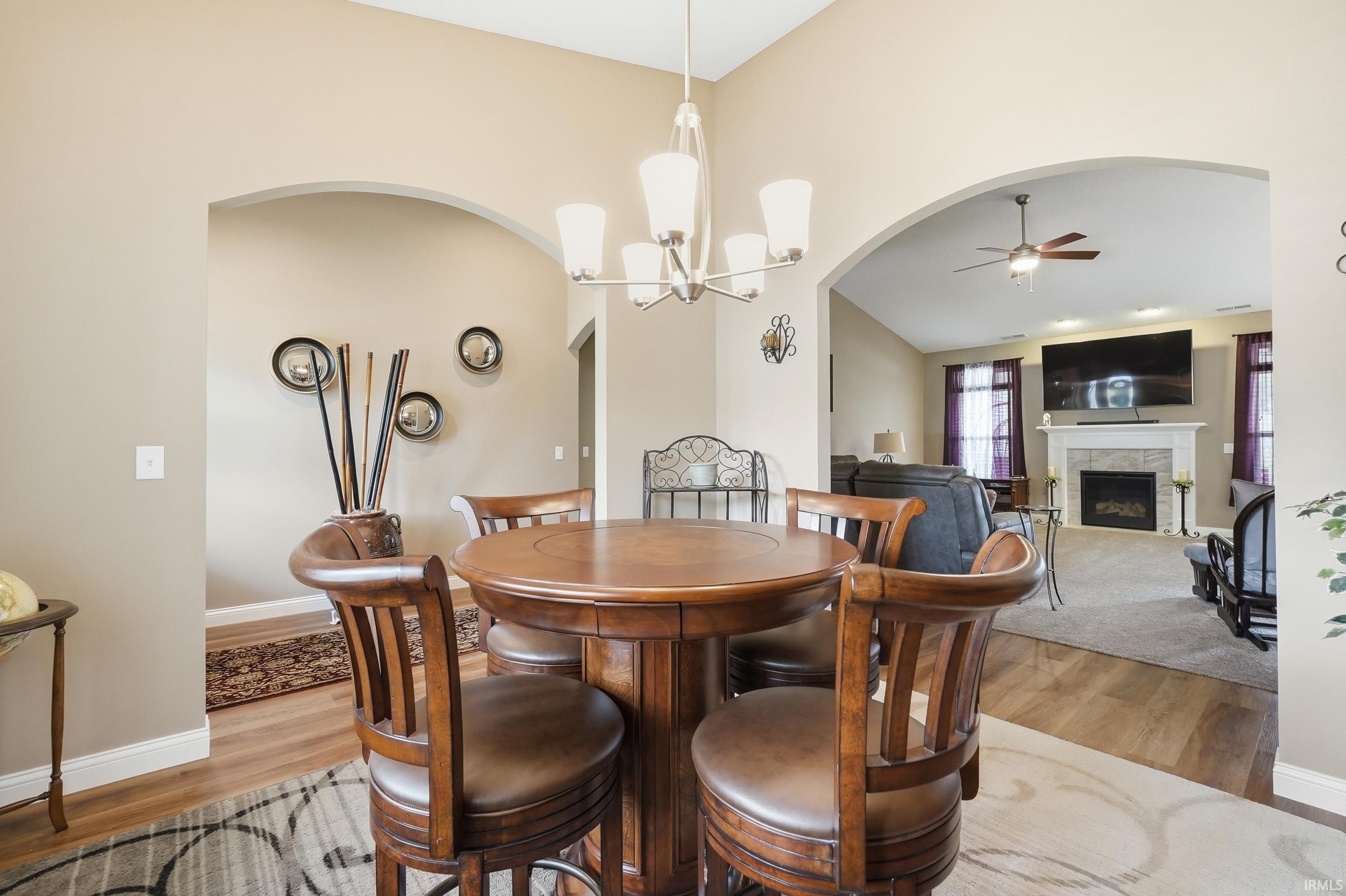 Central dining area featuring an overhead chandelier and arched doorways