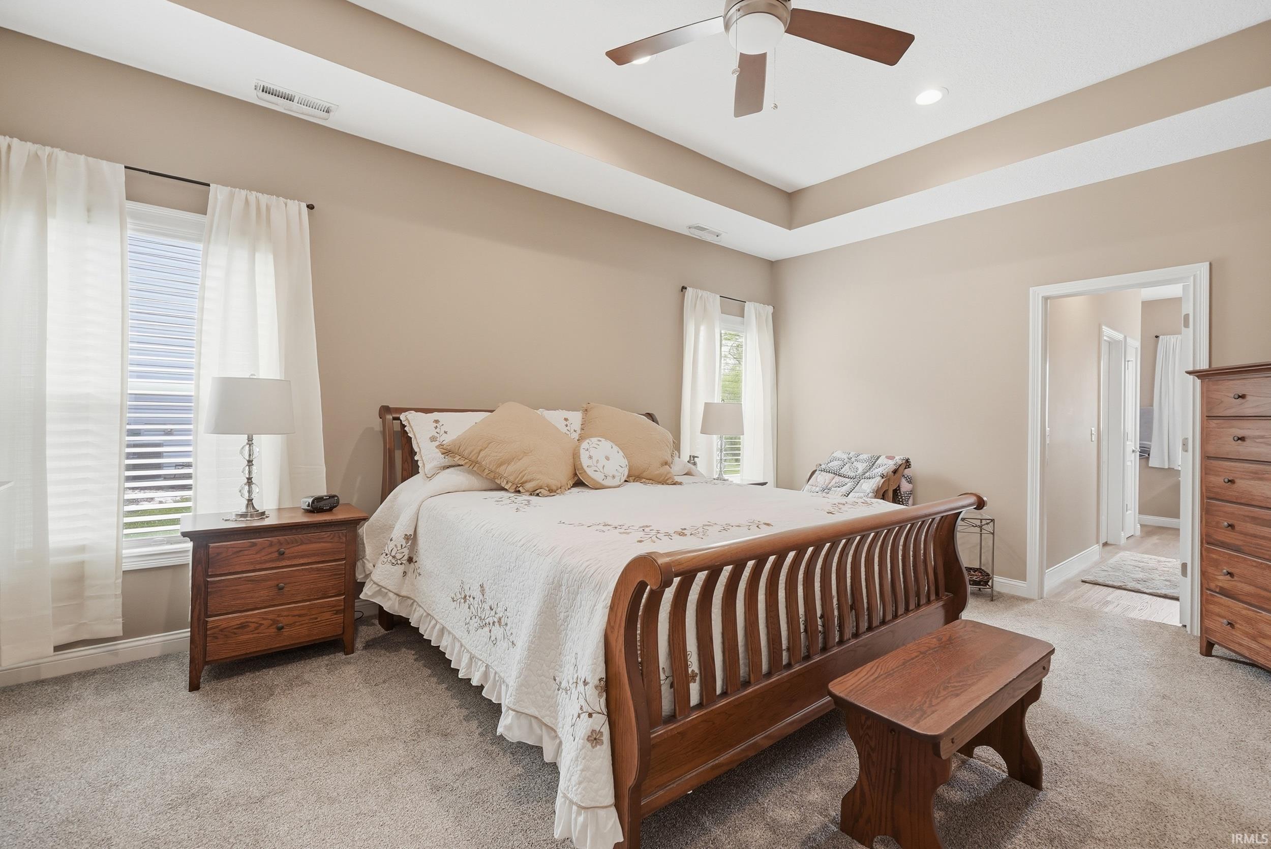 Tray ceiling with recessed lighting and a ceiling fan