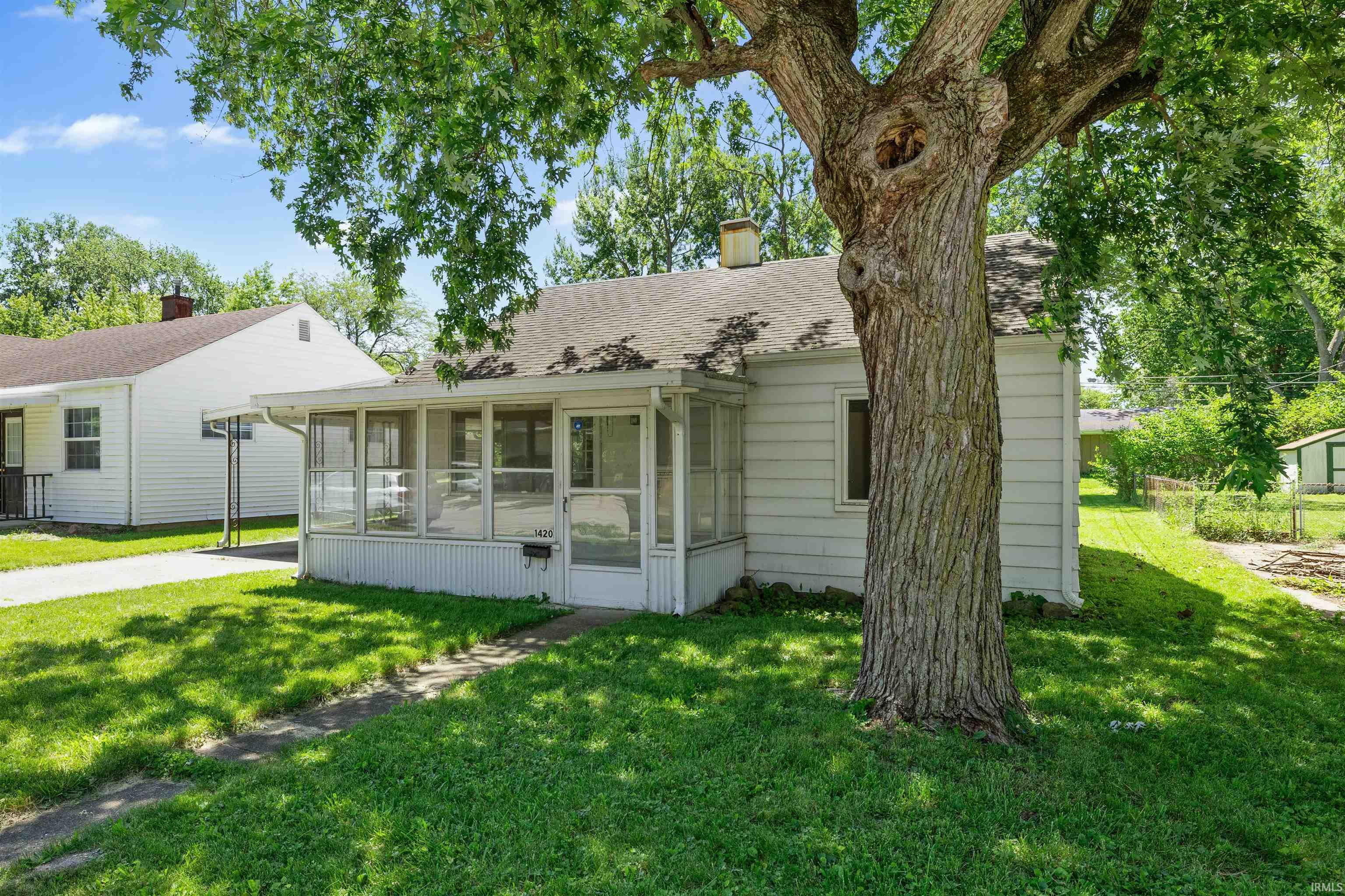 White siding residence with an enclosed front porch