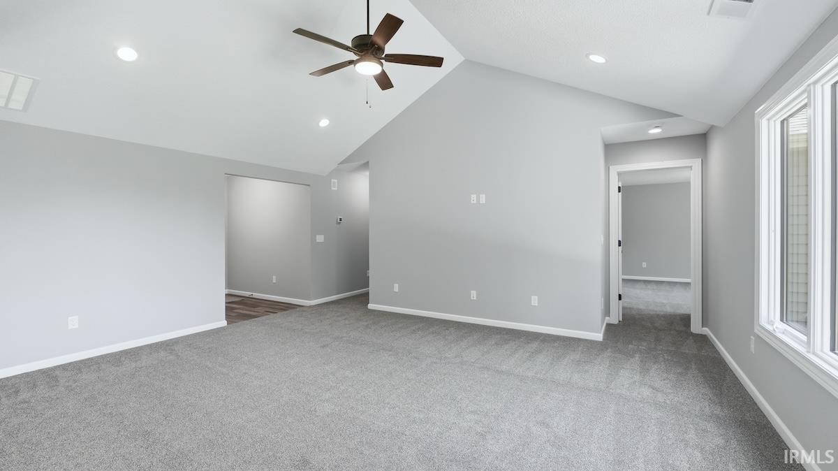 Spacious room with vaulted ceilings and recessed lighting