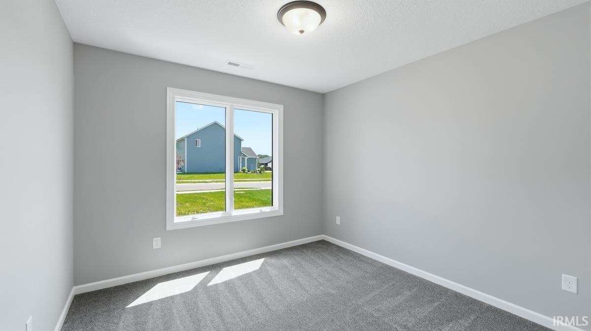 Neutral gray walls complemented by gray carpeting and white trim