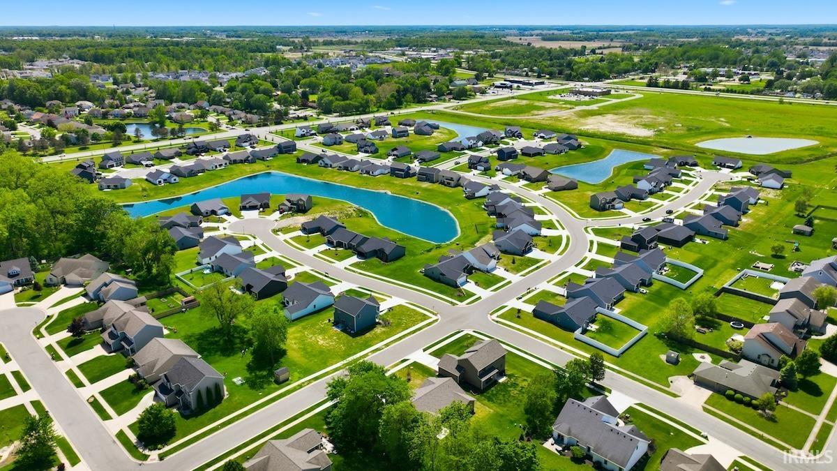 Residential neighborhood featuring a series of modern homes, curved streets, and multiple water features