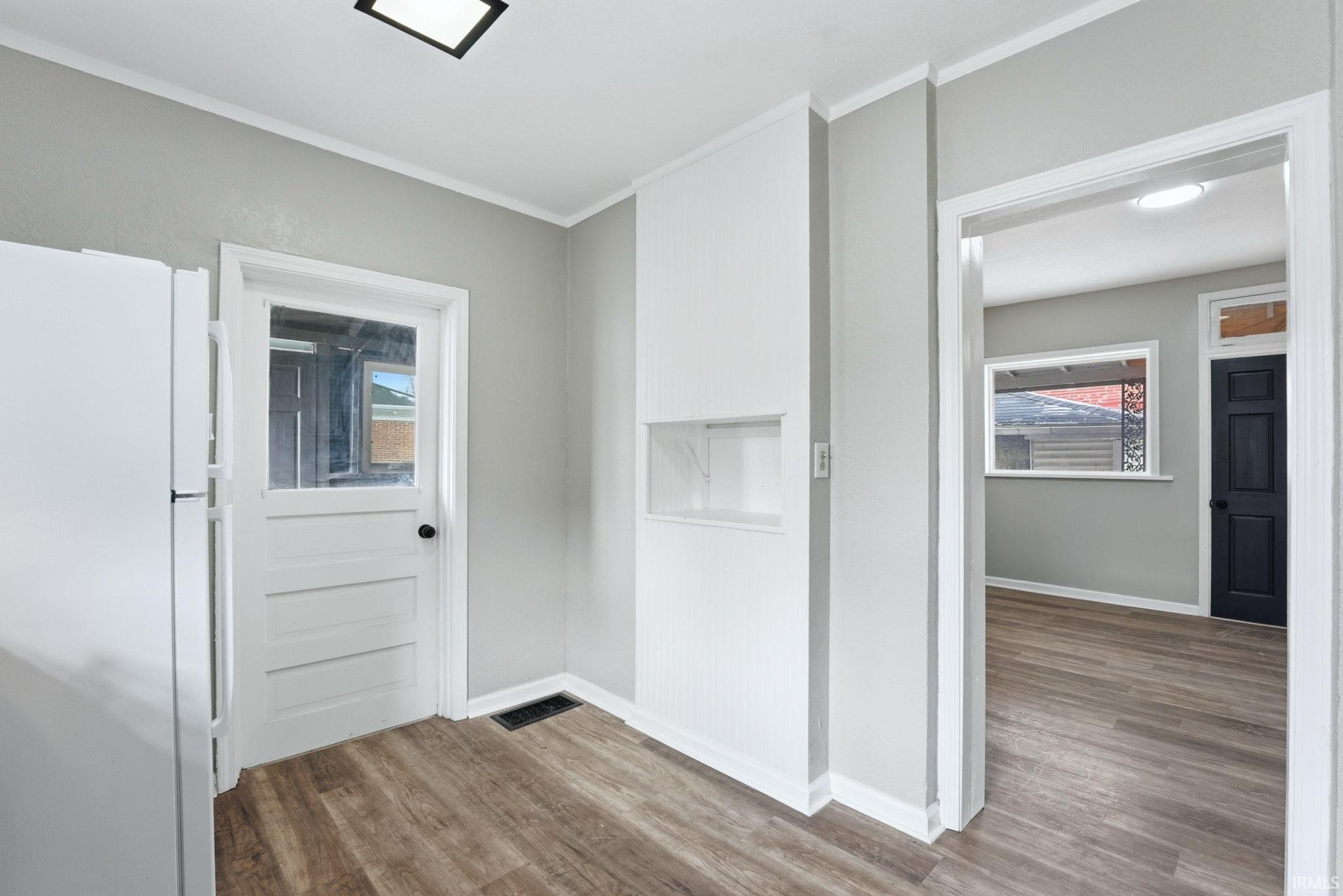 Interiors featuring wood-finish flooring and light gray walls