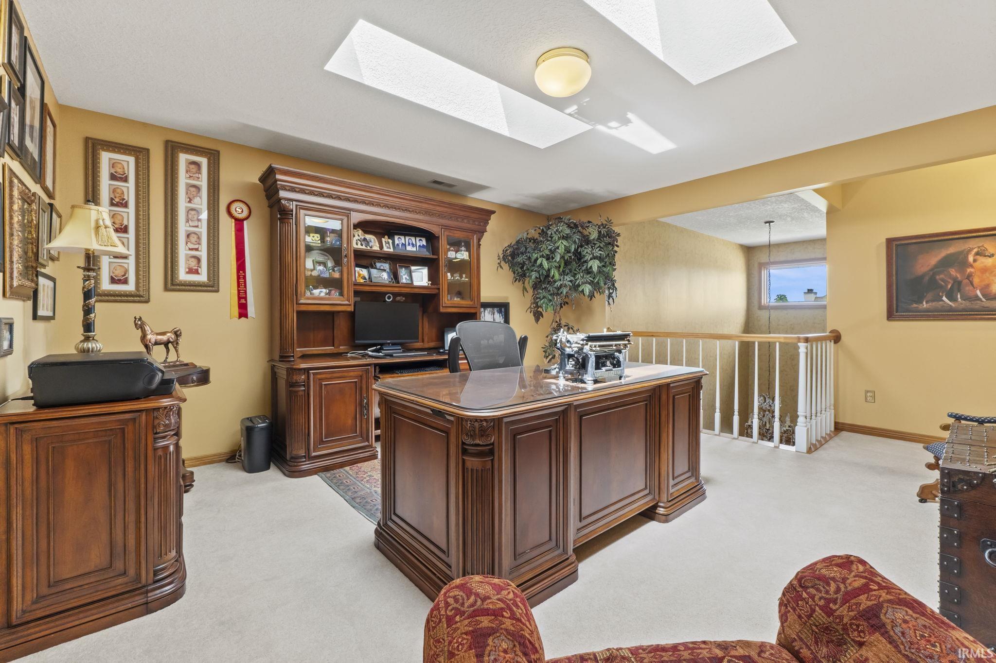 Dedicated room featuring light-toned carpeting, warm-toned walls, and a recessed ceiling light